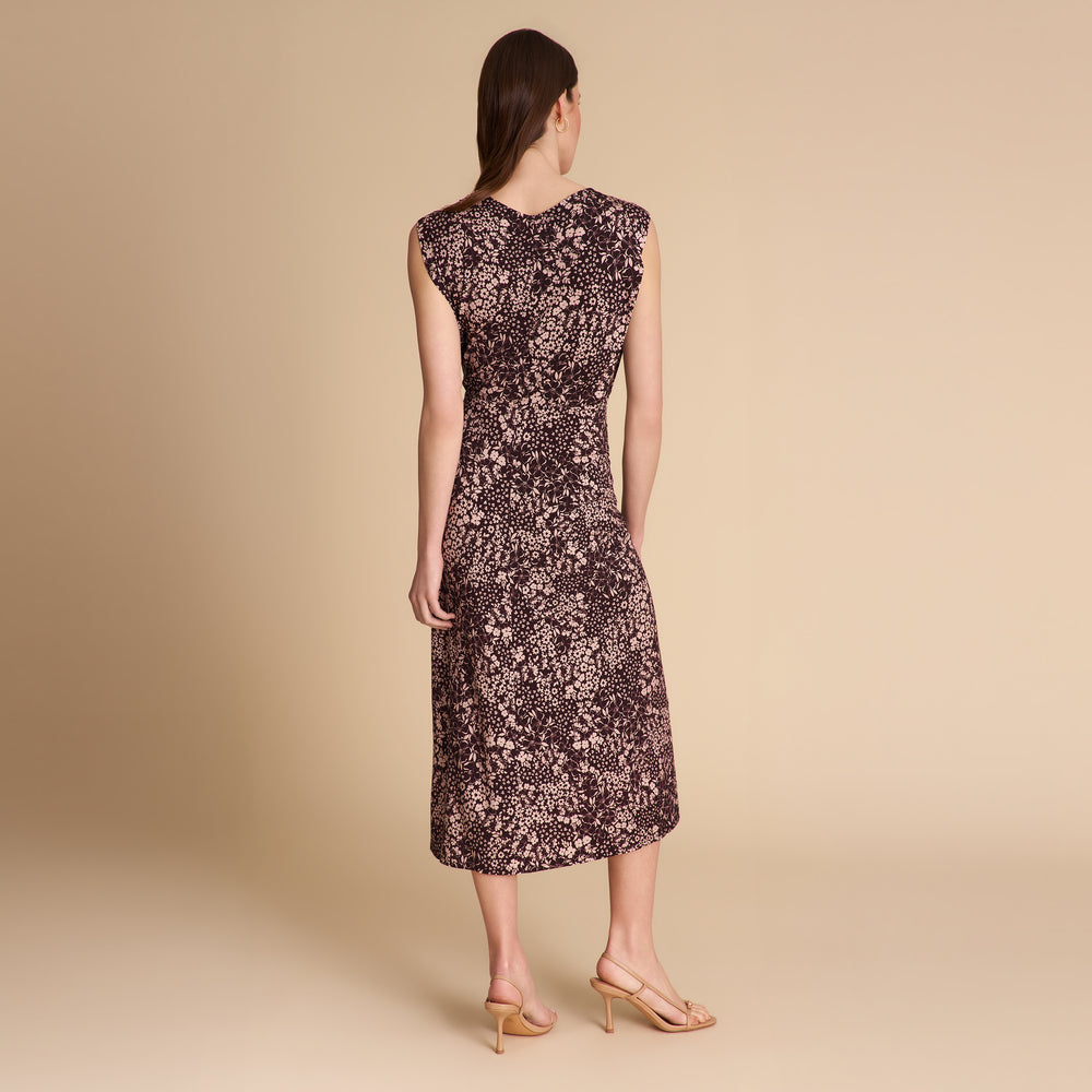 Woman wearing a floral dress on a beige background