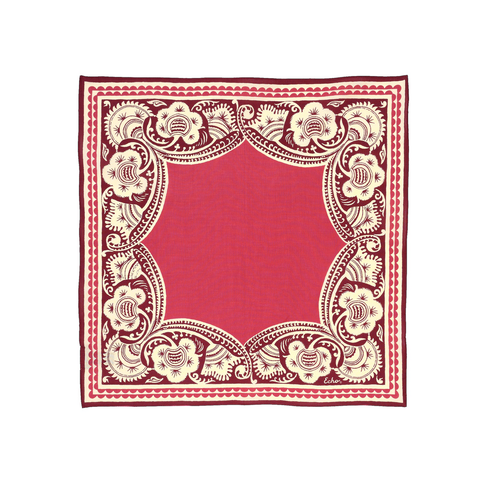A square bandana scarf featuring a vibrant red center and a detailed cream-colored floral border, displayed flat against a white background.