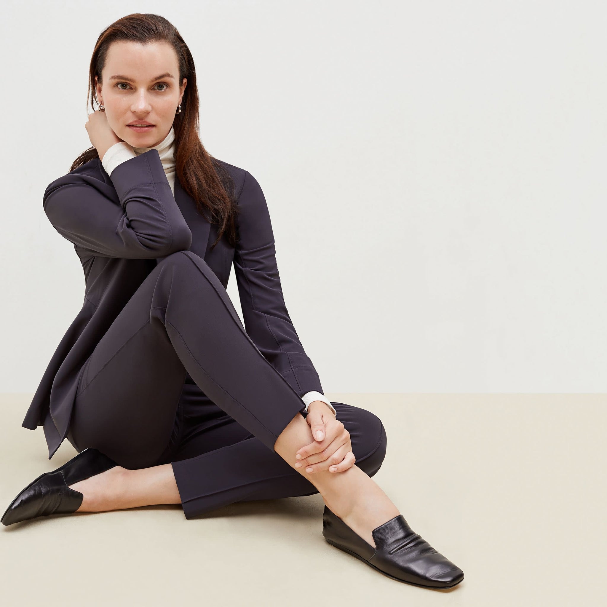 Detail image of a woman sitting wearing the Colby Jogger in Cool Charcoal