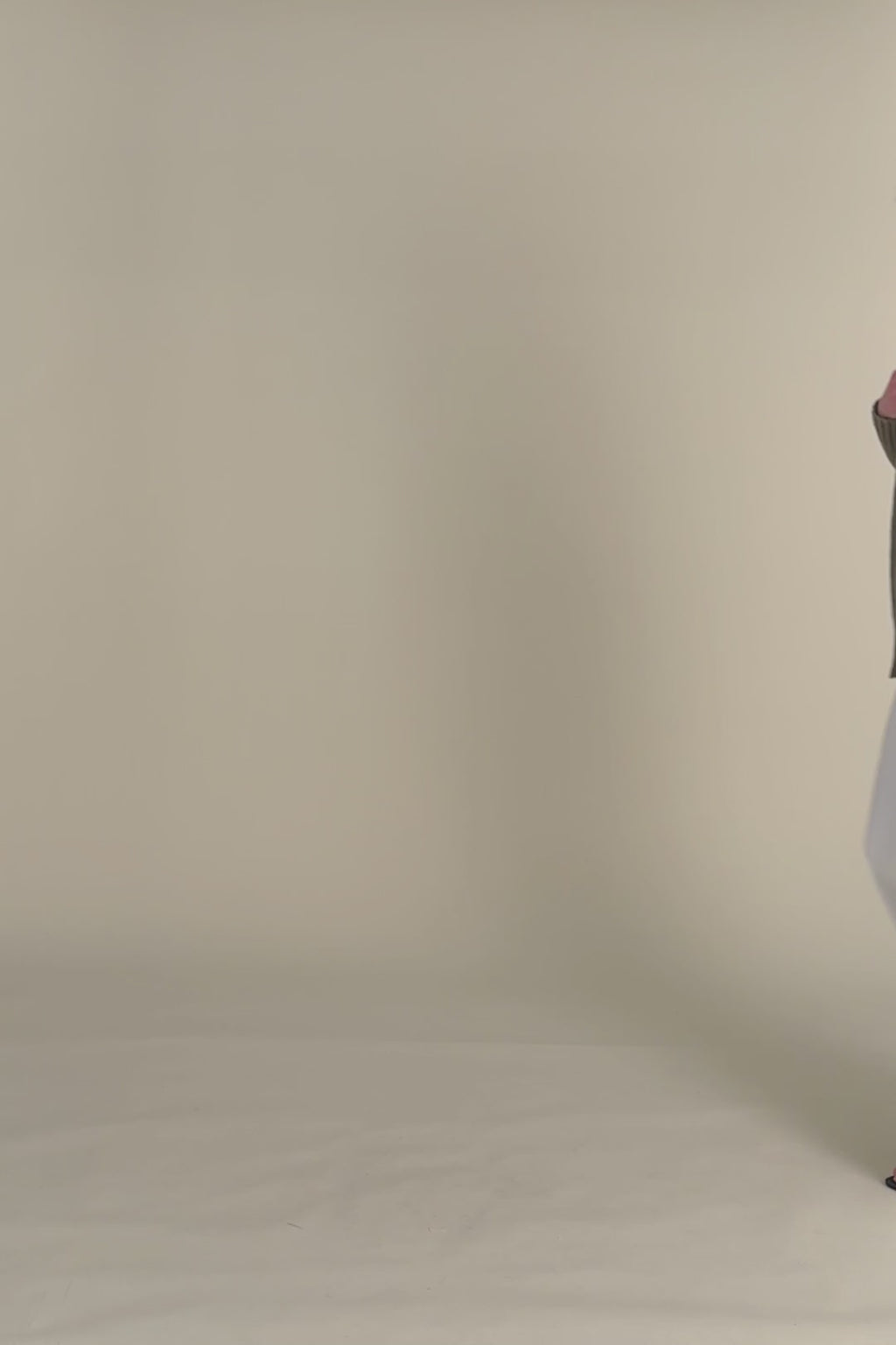 woman in green cardigan with white jeans. 