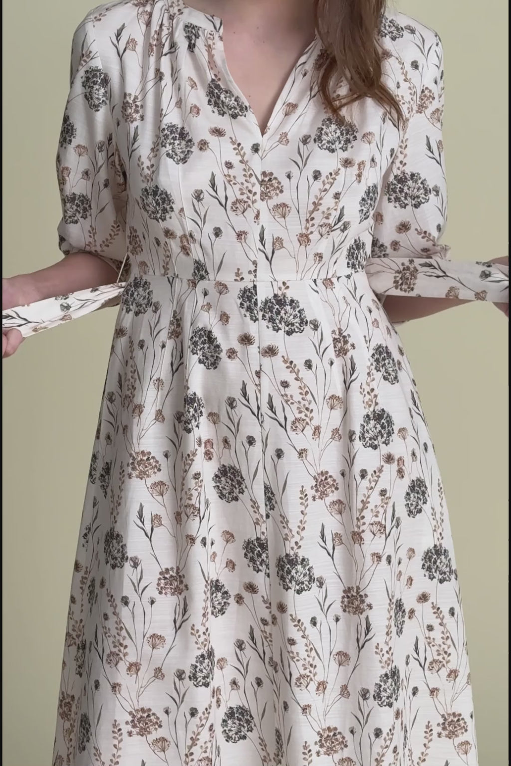 woman in tessie dress on beige background. 