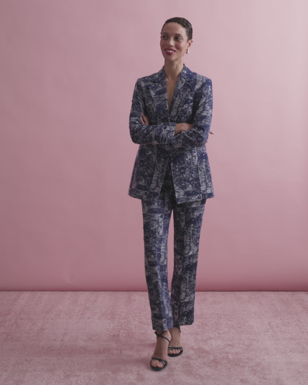 Floral-patterned pants worn by a person on a beige background.