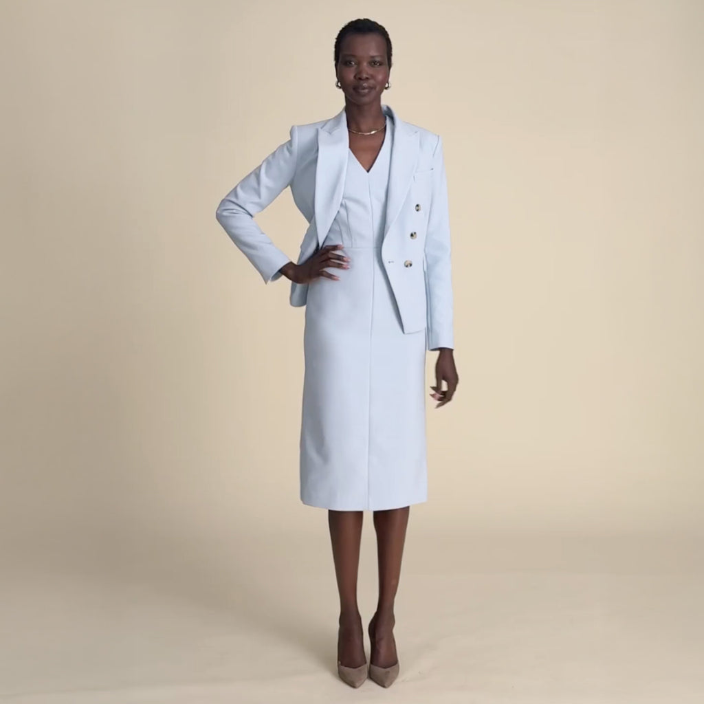 woman in light blue blazer with matching dress.