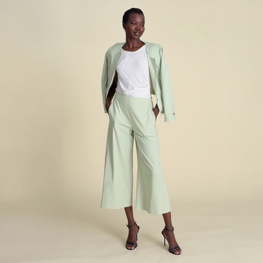Video of a woman wearing the green Aniya jacket and matching pants