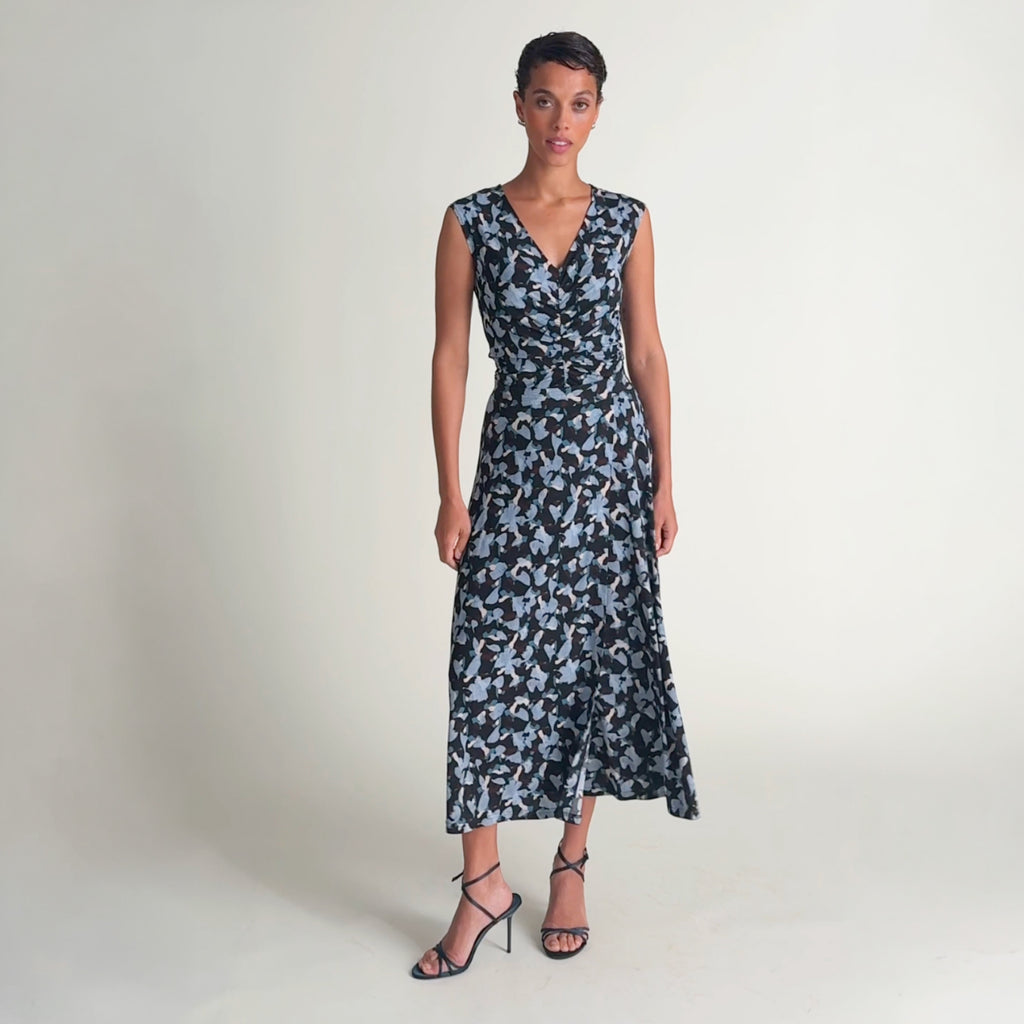 Woman wearing a matching top and skirt in abstract bluebird walking