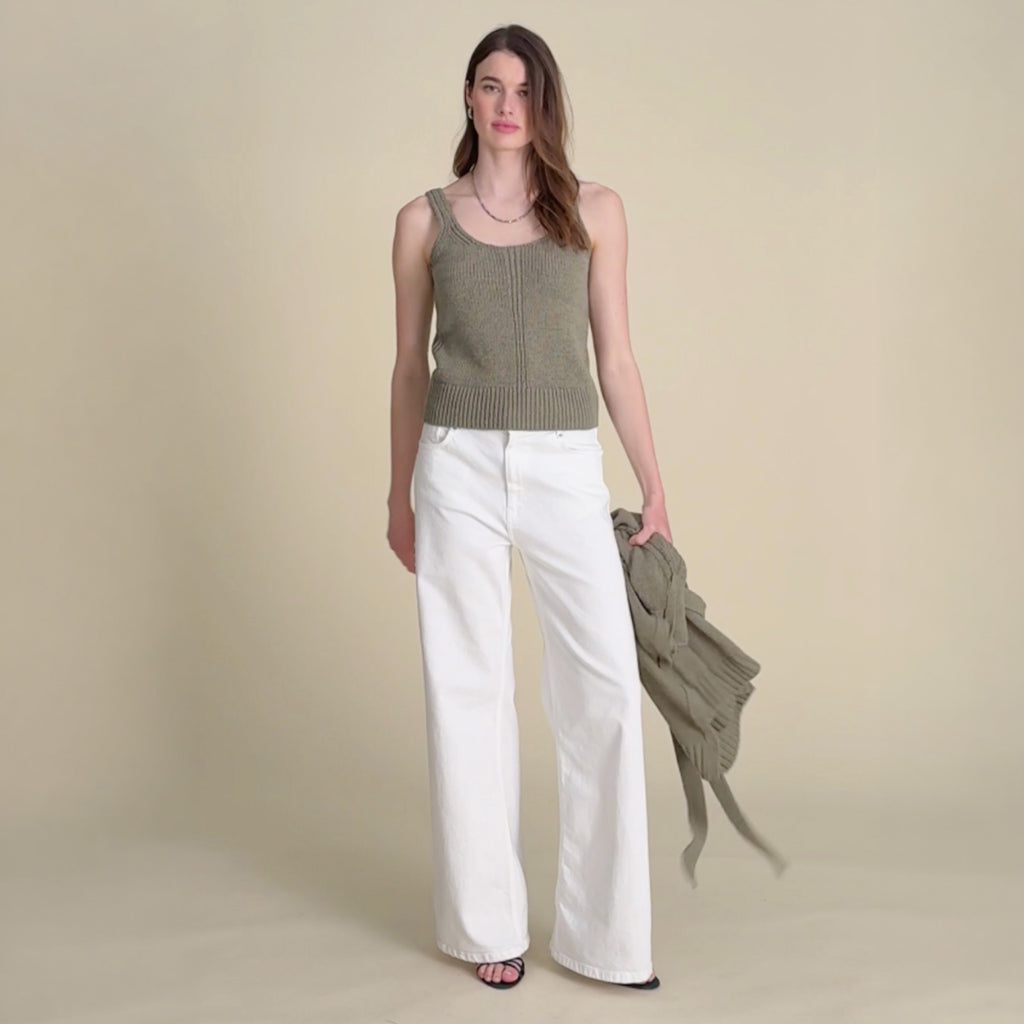 woman in green top with white jeans.