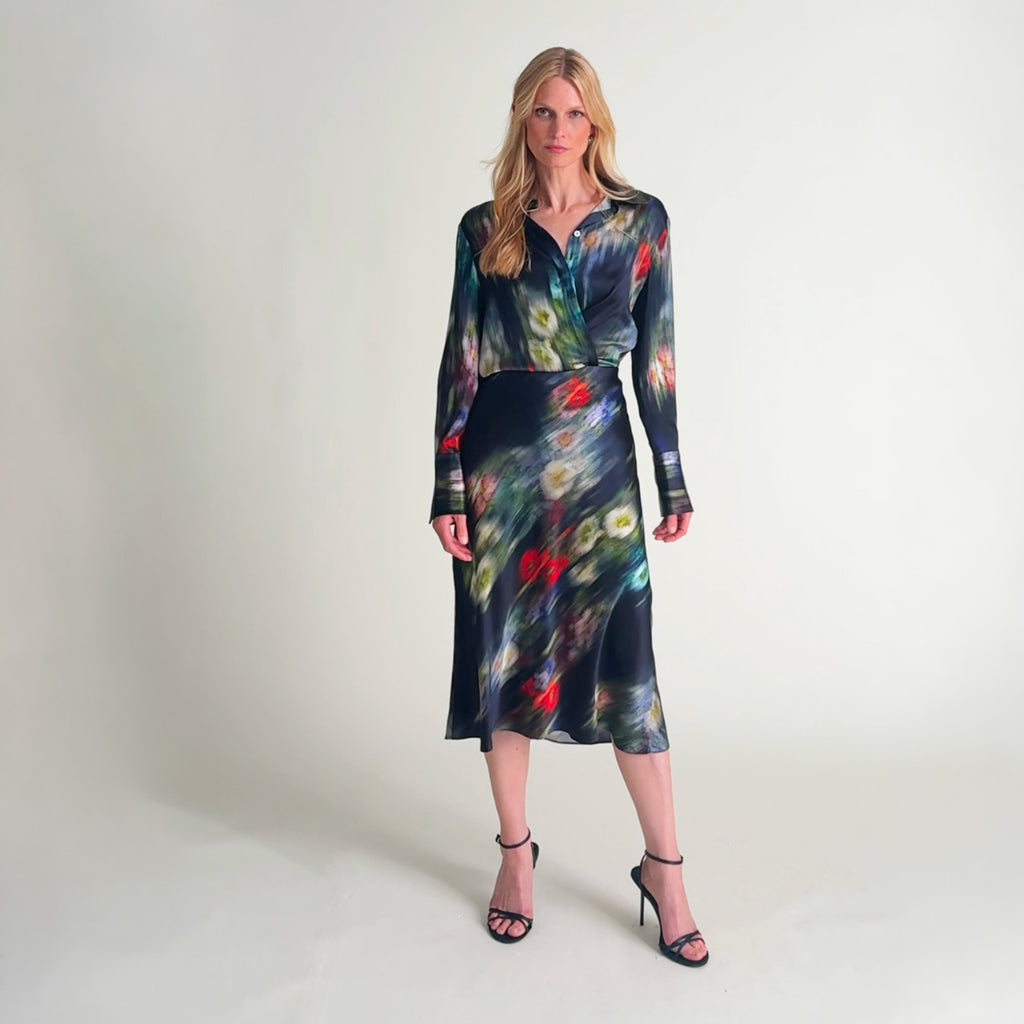 Woman wearing the tatum blouse and orchard skirt in garden haze