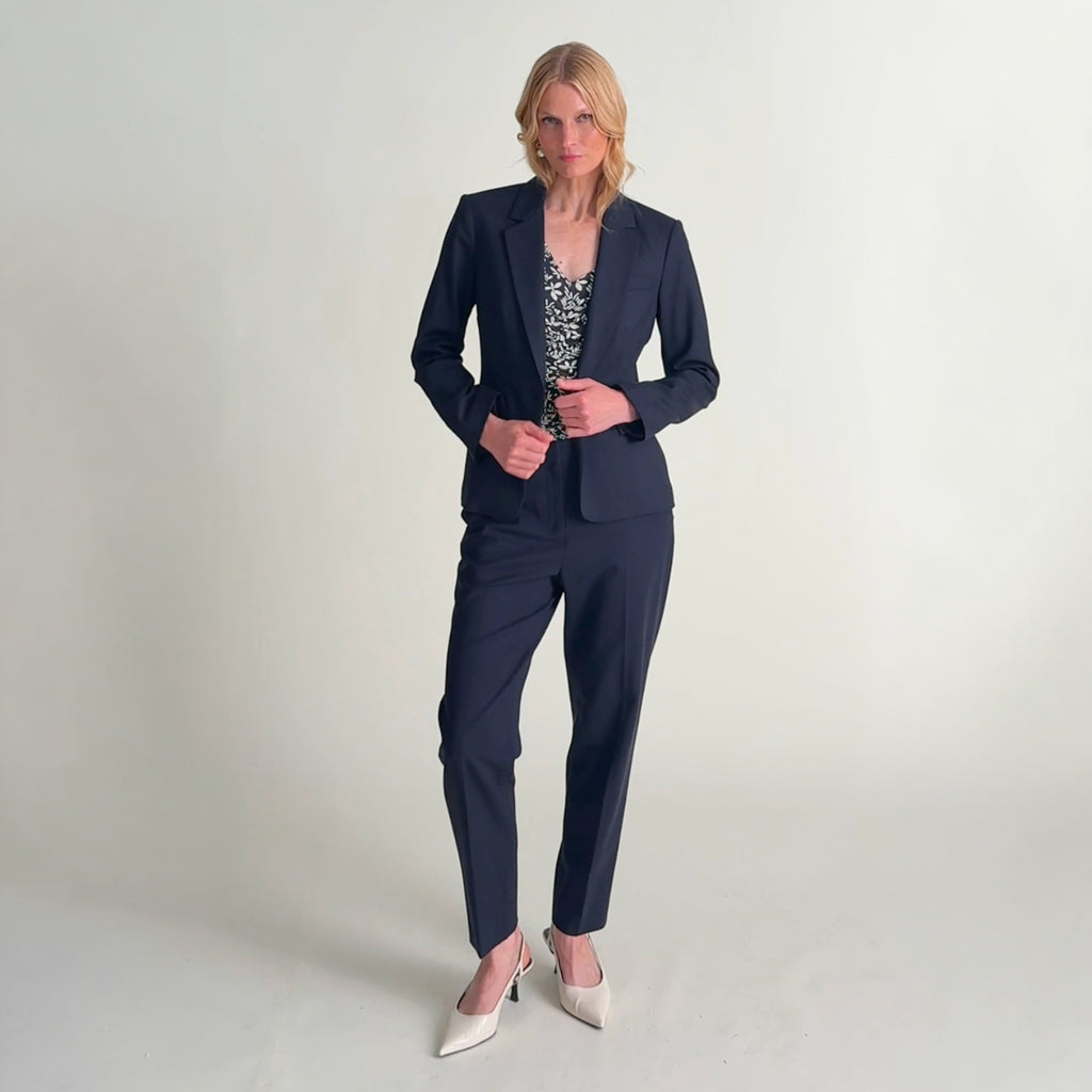 Woman wearing the mejia pant in dark navy, yiyan in dark navy, and franka cece top in happy floral
