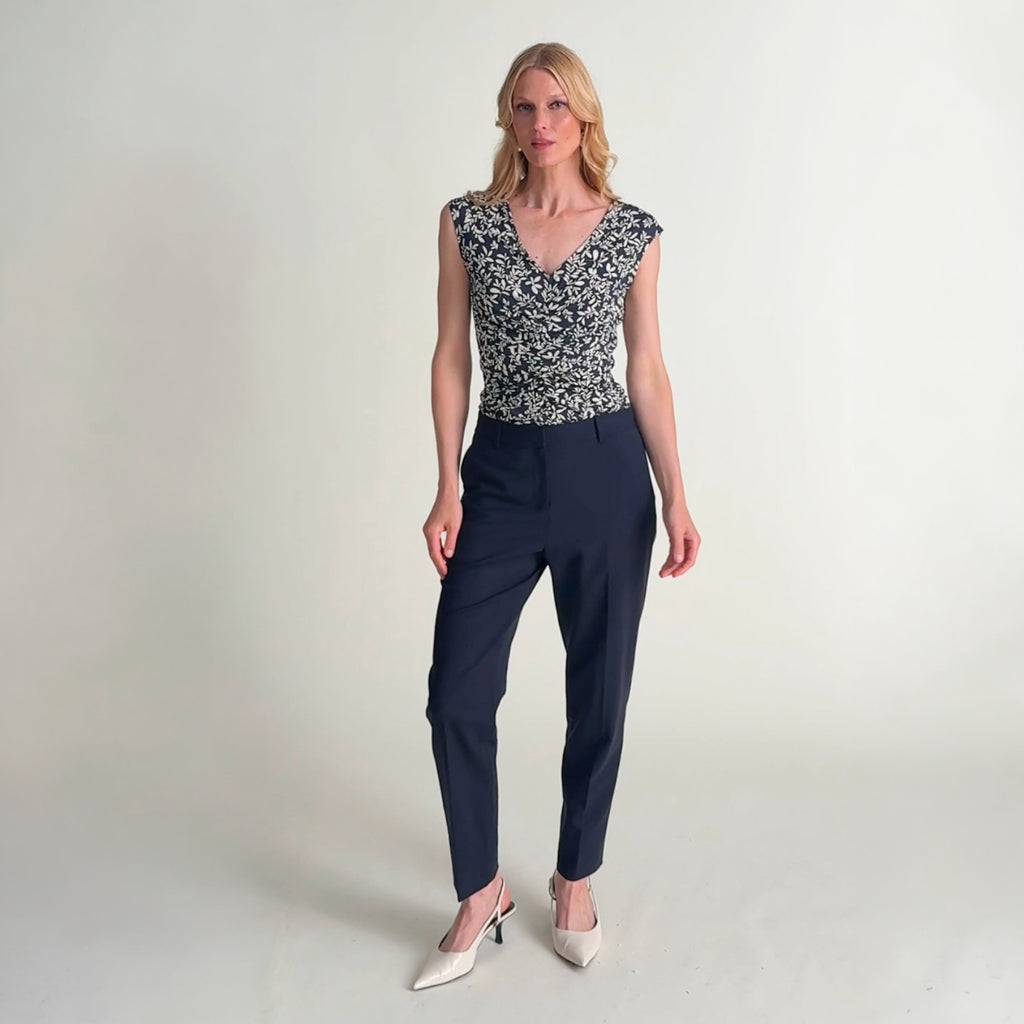 Woman wearing the smith pant in dark navy and cece top in happy floral