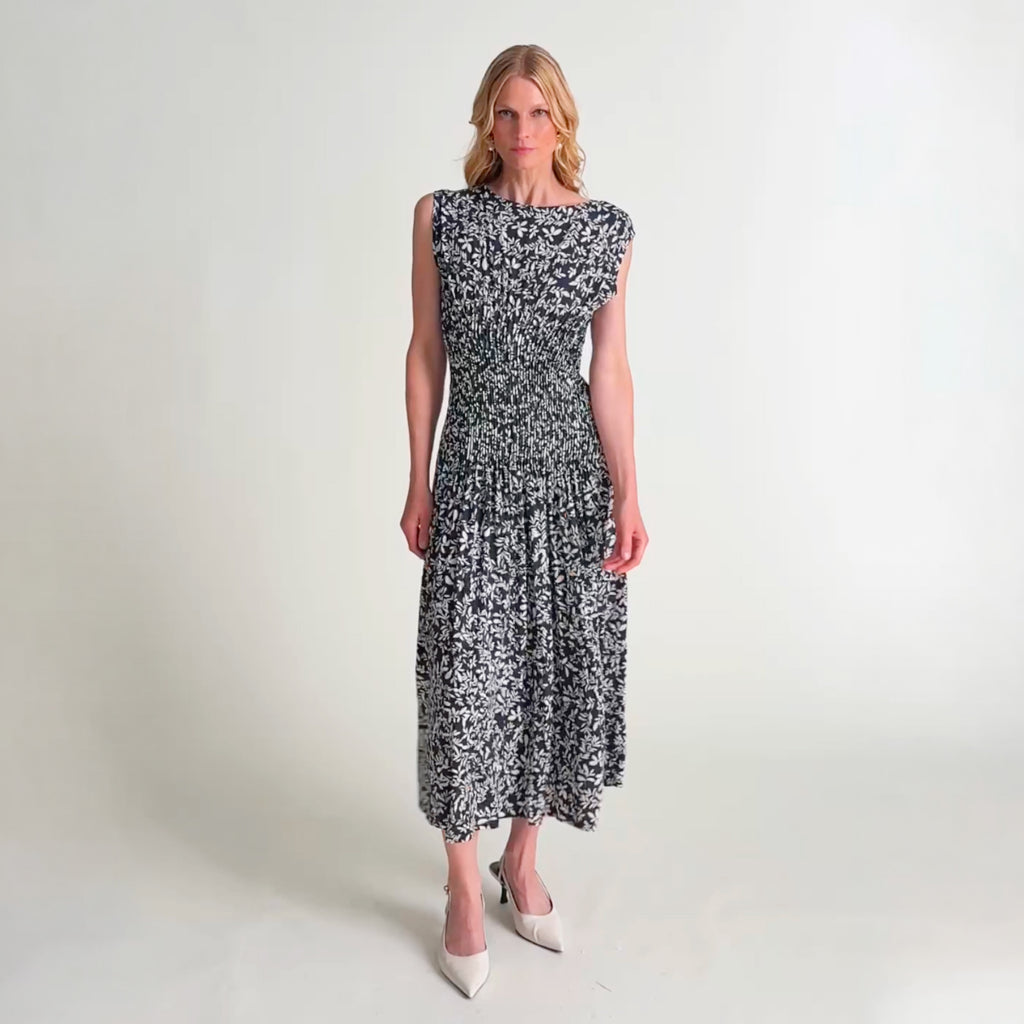 Woman wearing the Fia dress in leaf line fern