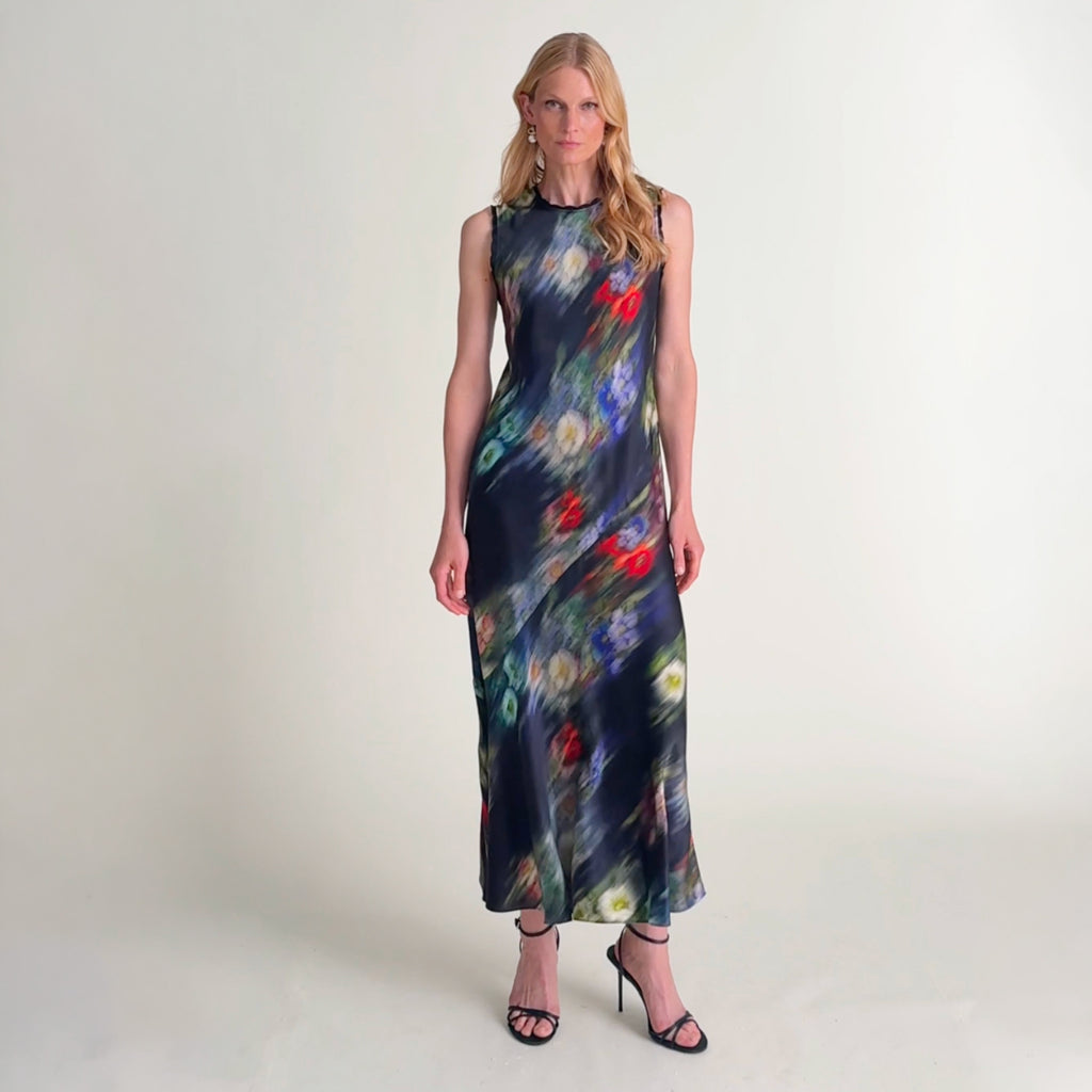 Woman wearing the camille dress in garden haze