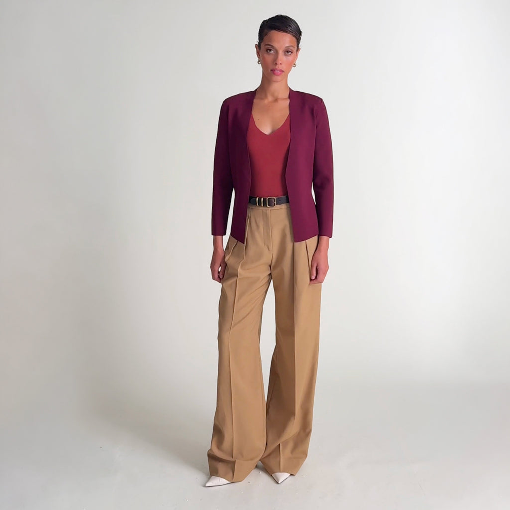 Woman wearing the woolf jardigan in port wine, the peggy top in fired brick, and the bia pant in macaroon