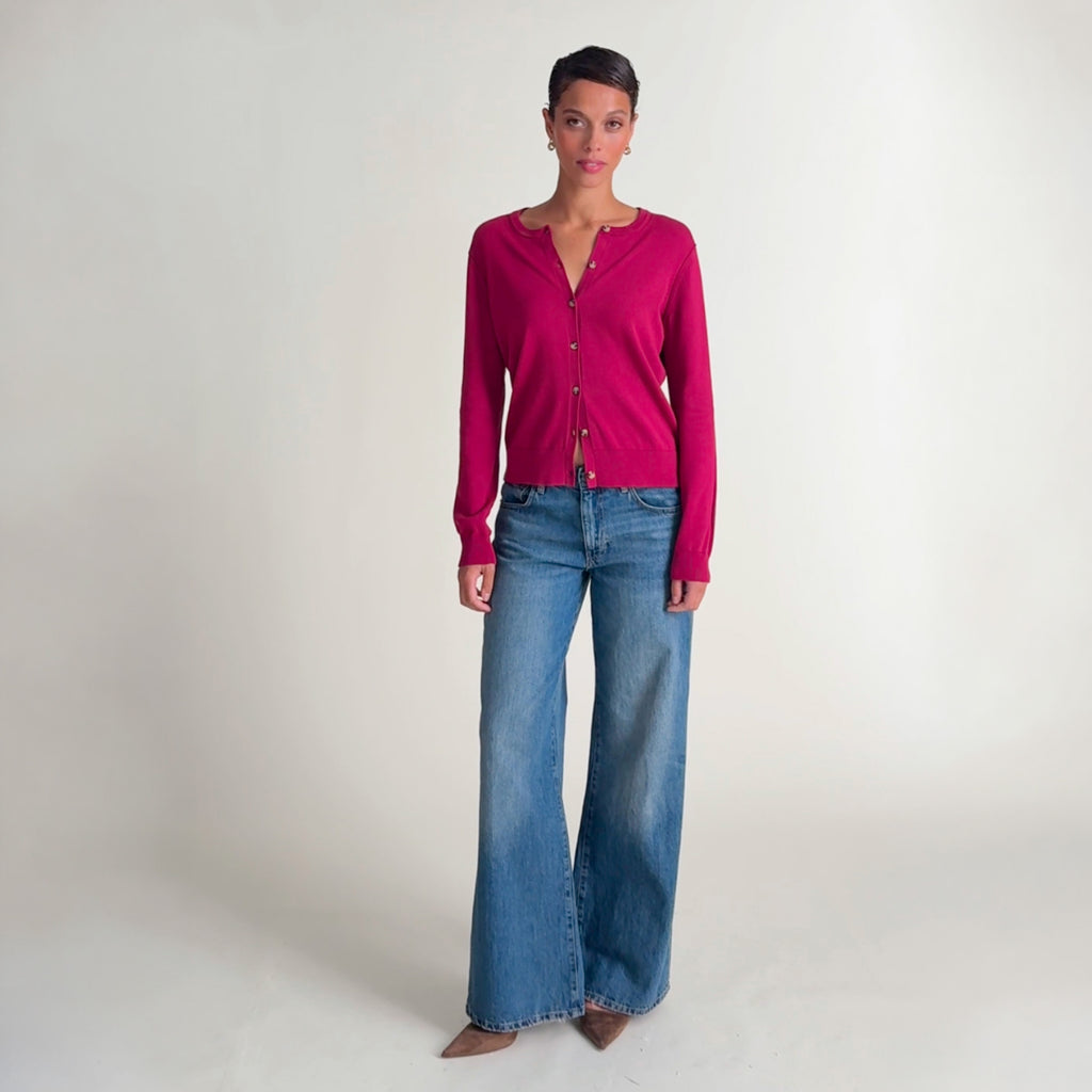 Woman wearing the mel cardigan in red and jeans