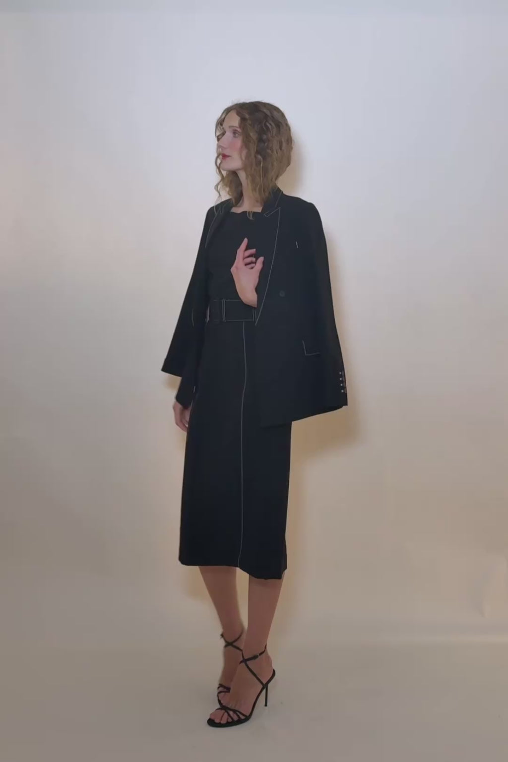 woman in black dress with matching blazer.