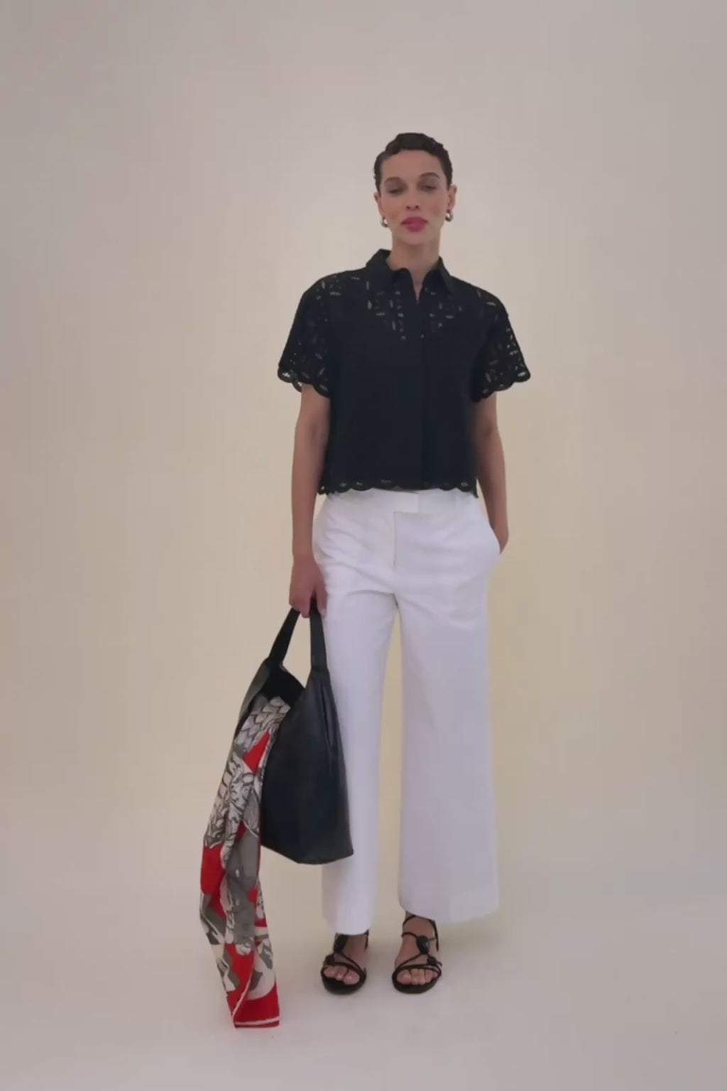 Women in Black top with white jeans.