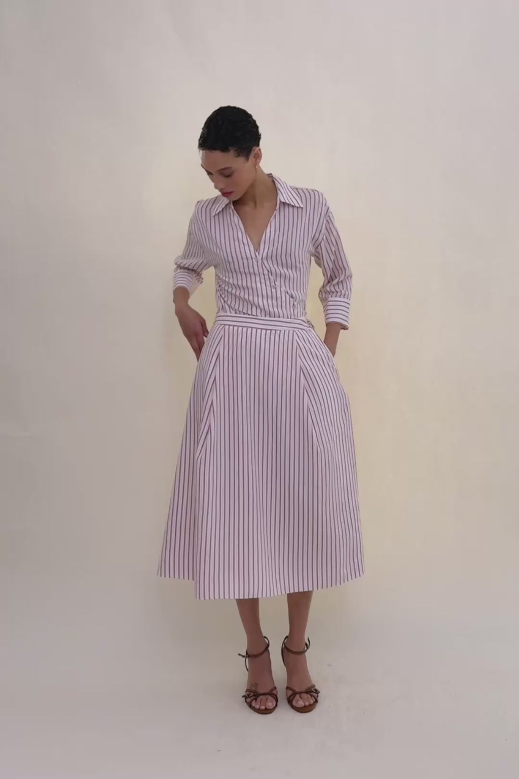 woman in stripped shirt with stripped skirt.