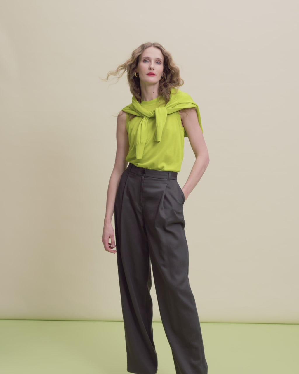 woman in pineapple top and dark trousers. 