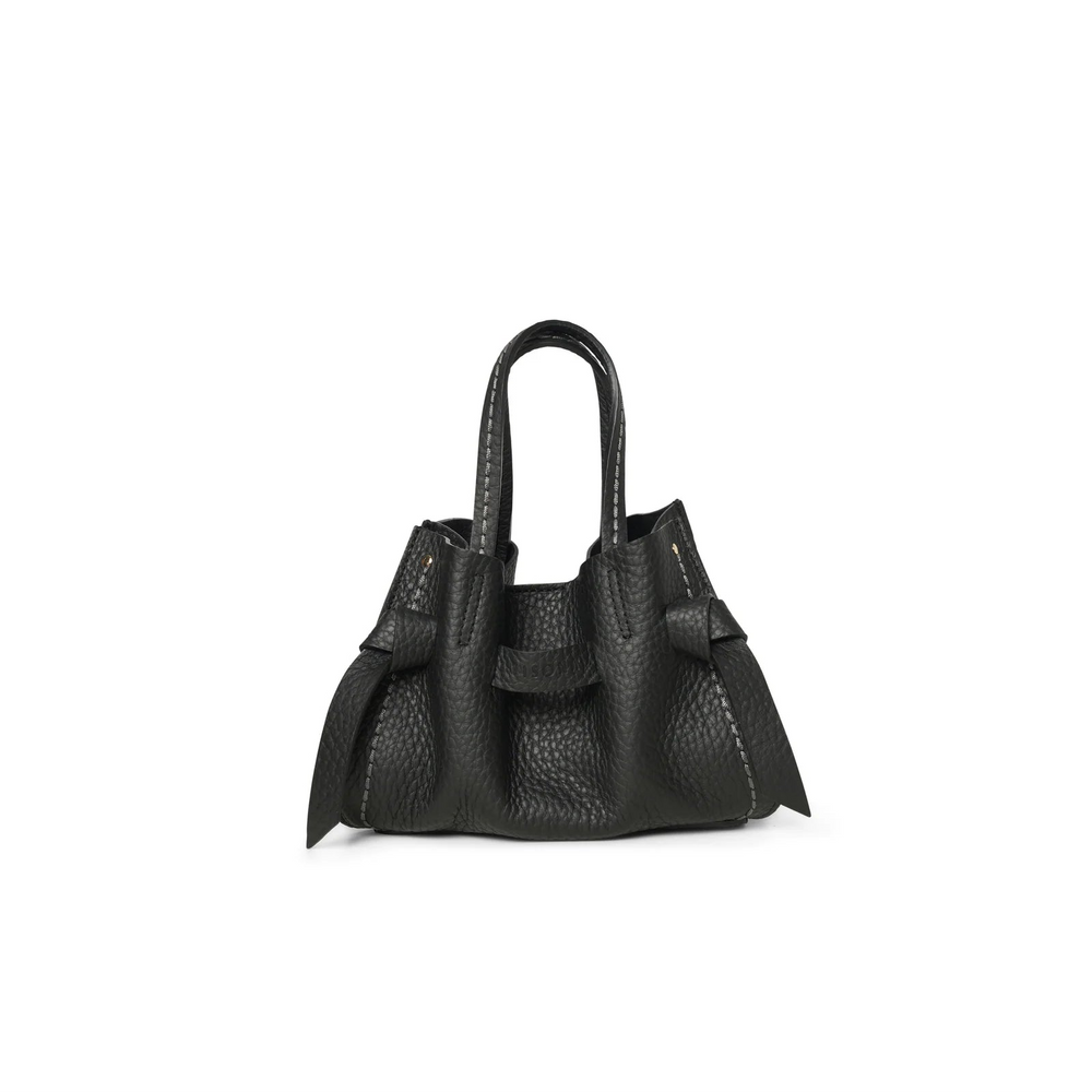 A small black pebbled leather handbag with double top handles and decorative side tabs, photographed against a plain white background.