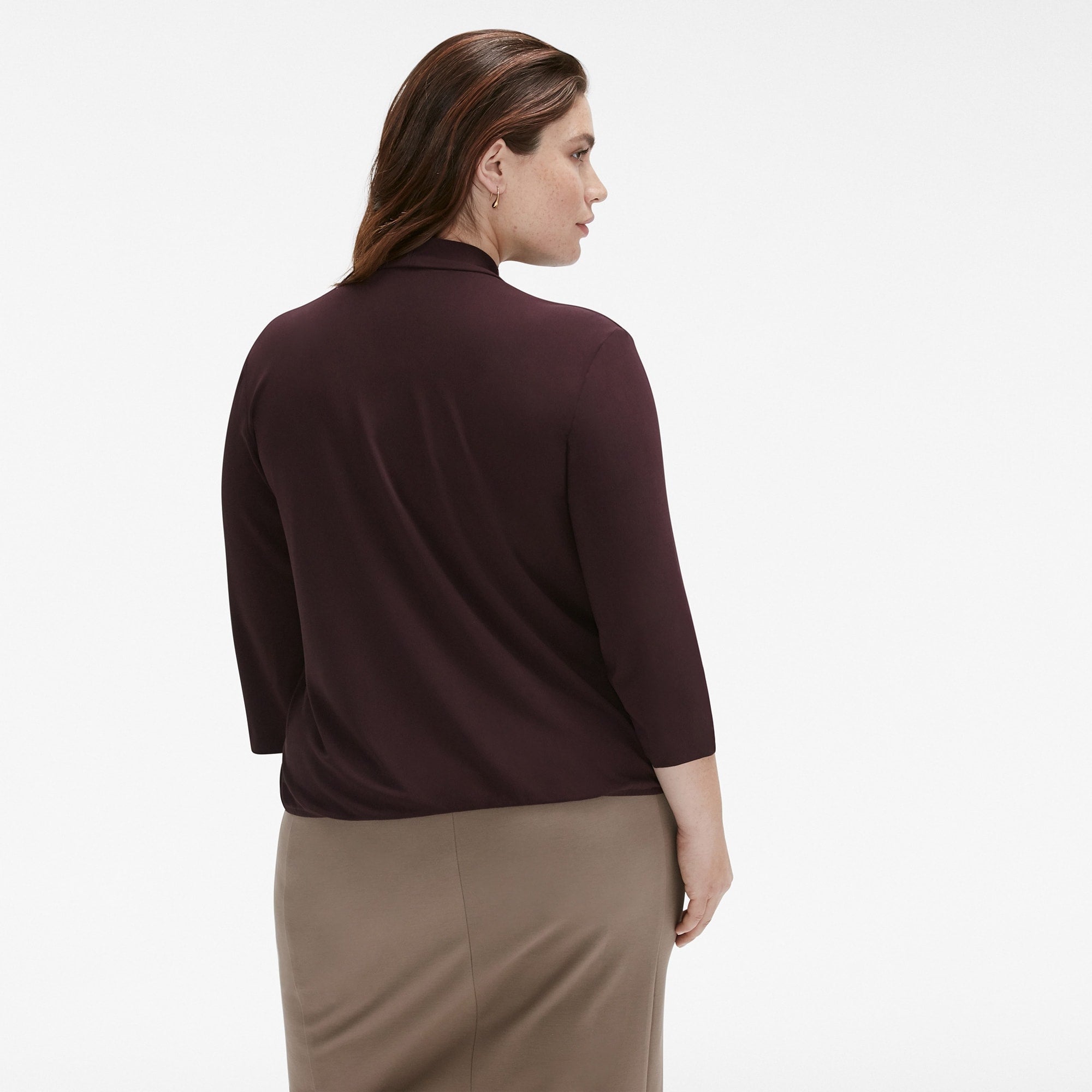Back image of a woman standing wearing the Deneuve Top in blackberry