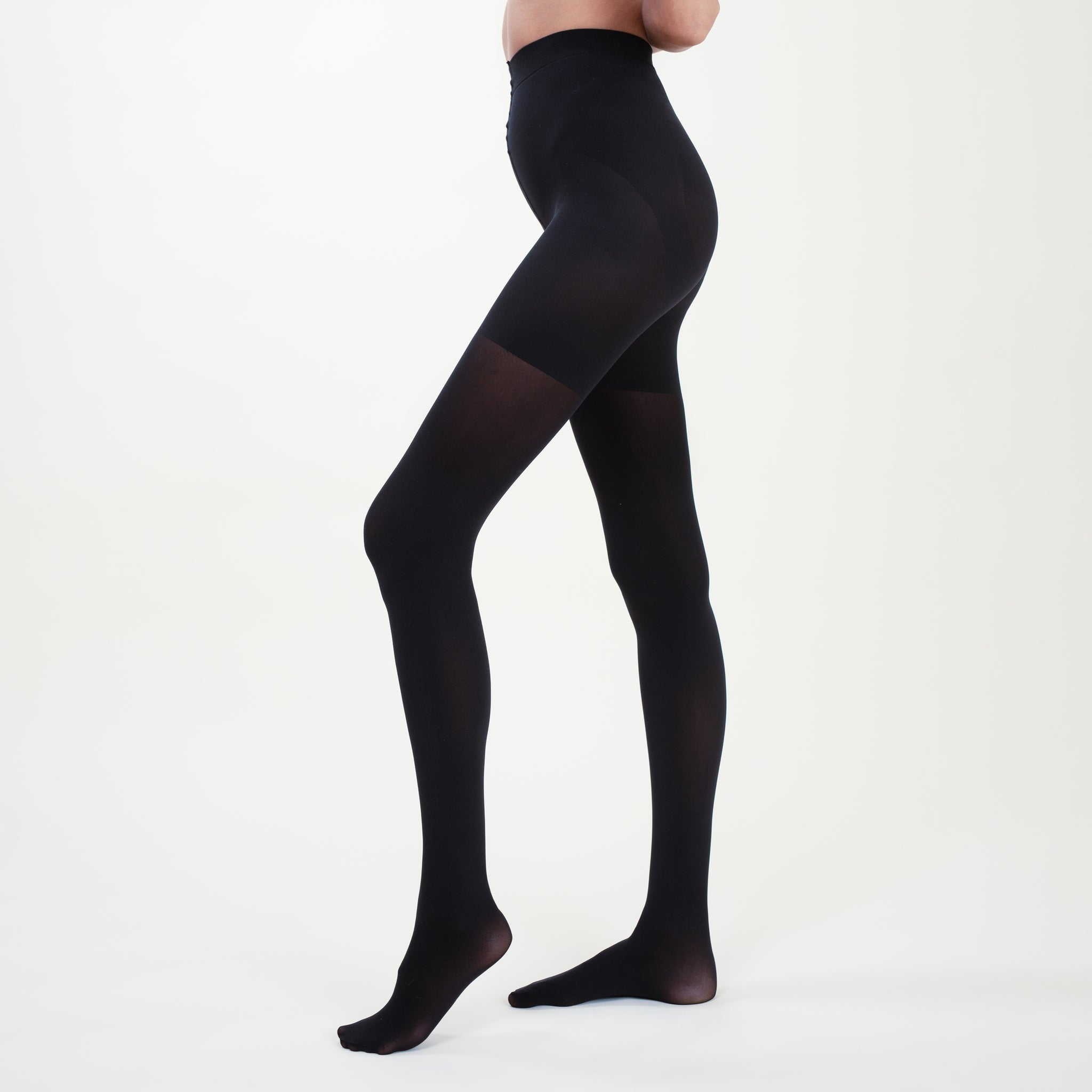 Side image of a woman standing wearing the Threads Opaque Tights in Black