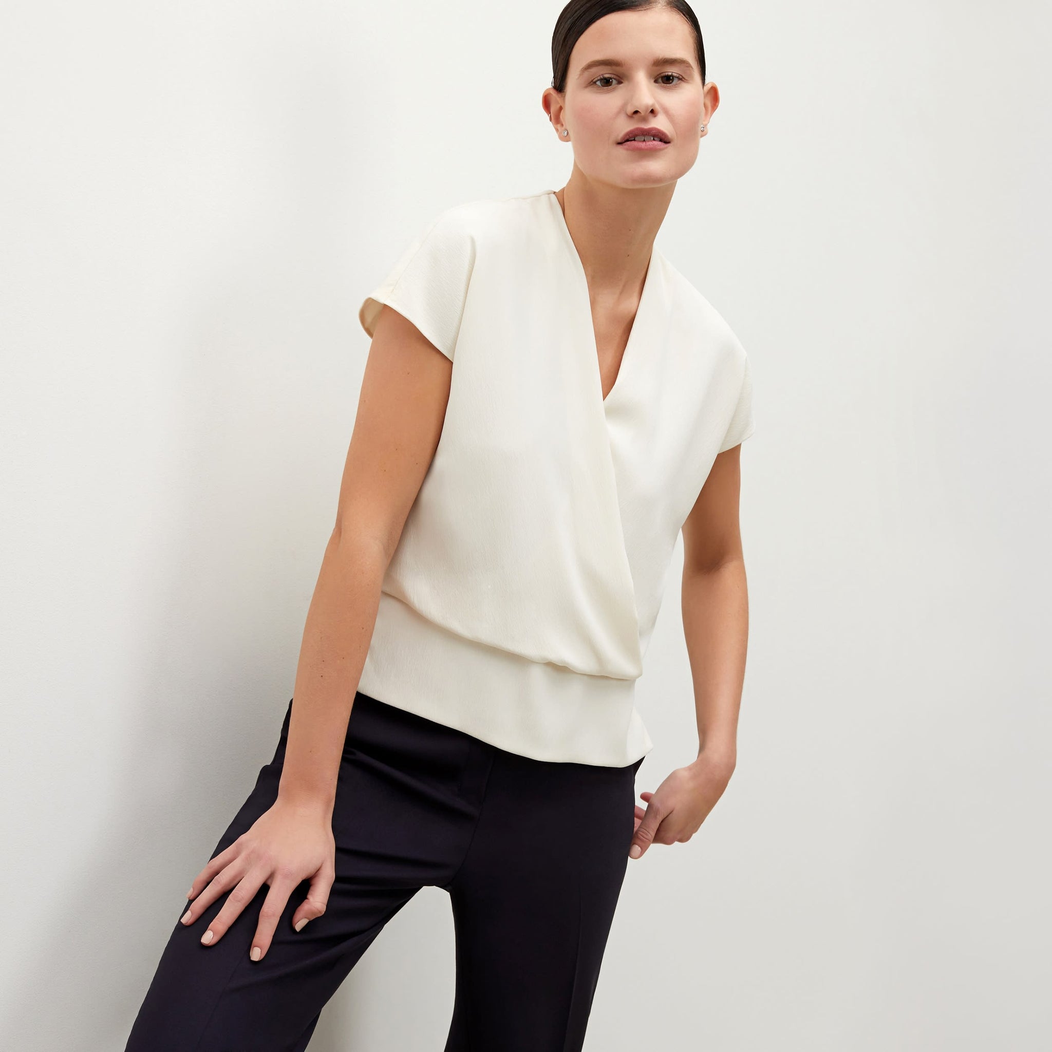 Front image of a woman standing wearing the Antonia Top—Soft Wave in Alabaster