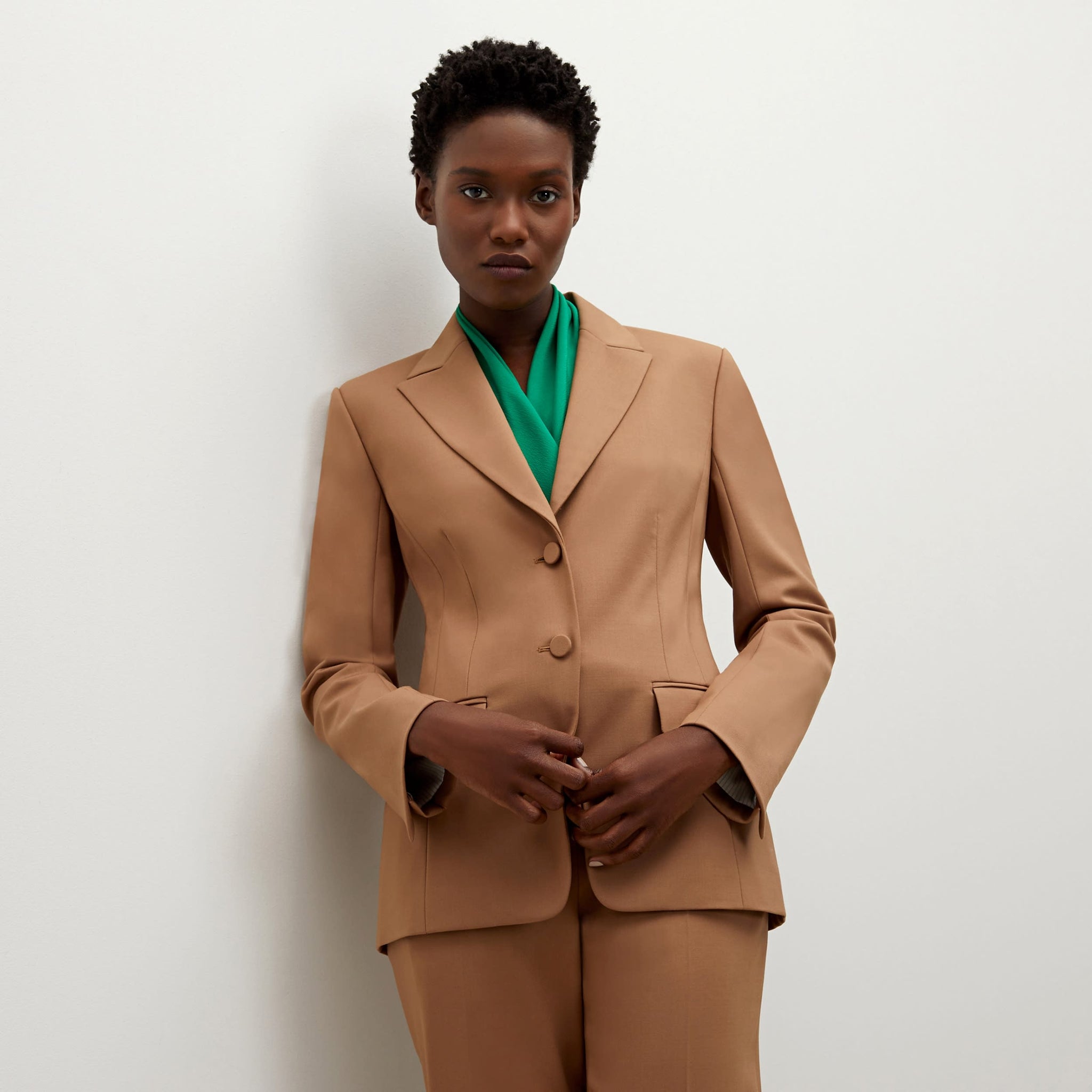 Front image of a woman standing wearing the bennett blazer wool twill in camel