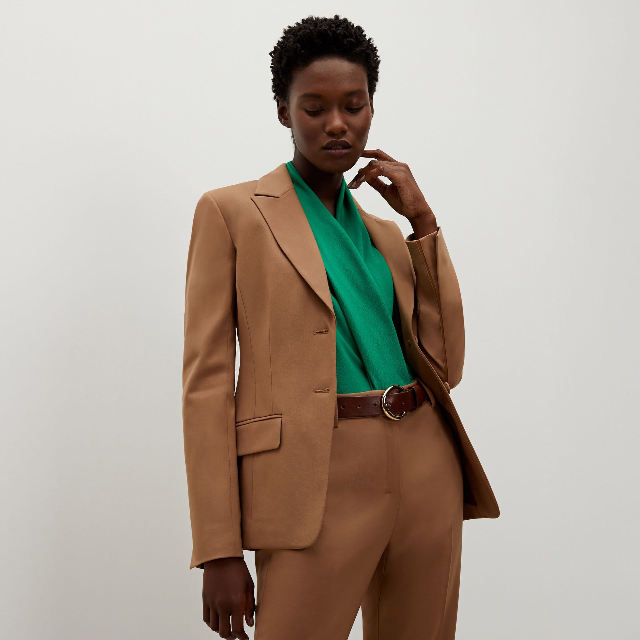Side image of a woman standing wearing the bennett blazer wool twill in camel