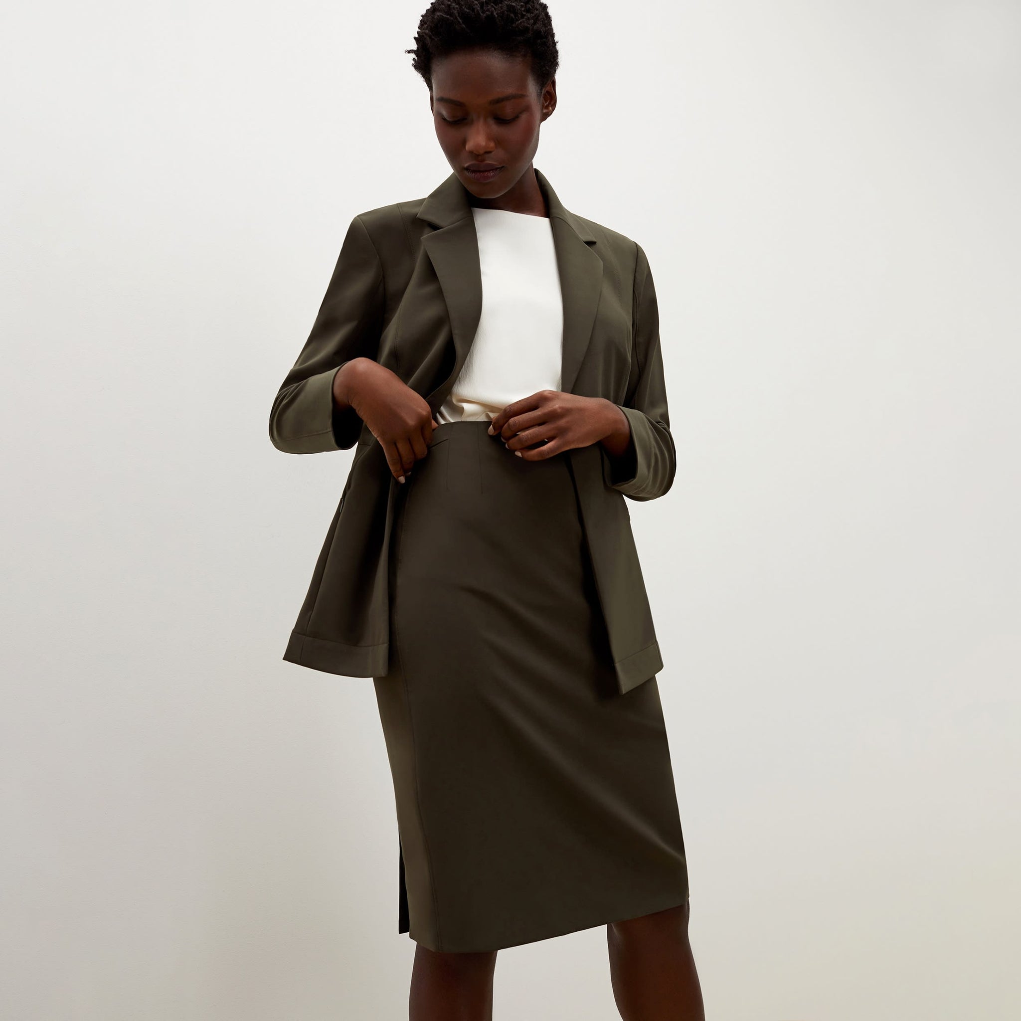Front image of a woman standing wearing the cobble hill packable suiting in olive