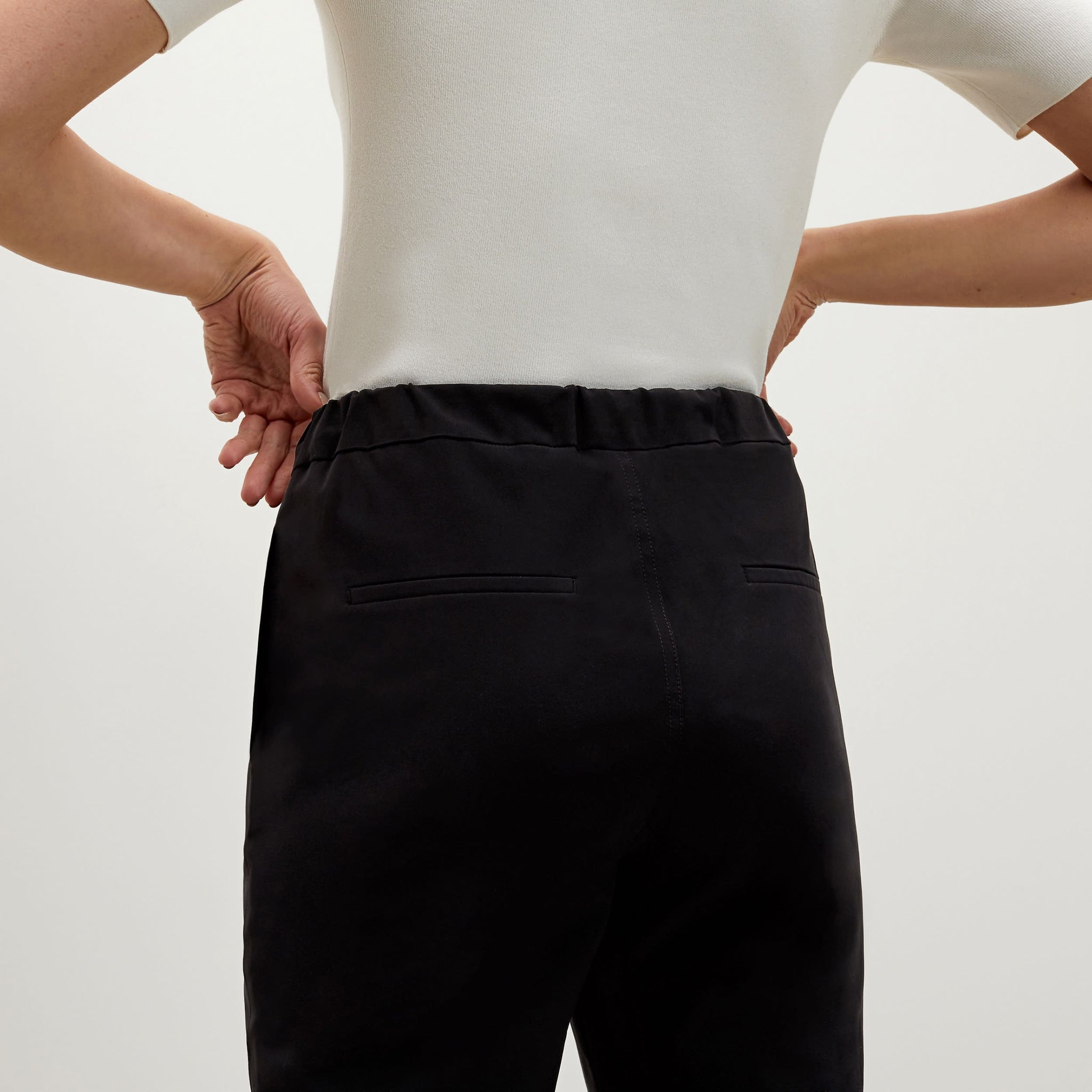 Back image of a woman standing wearing the Colby Jogger in Black