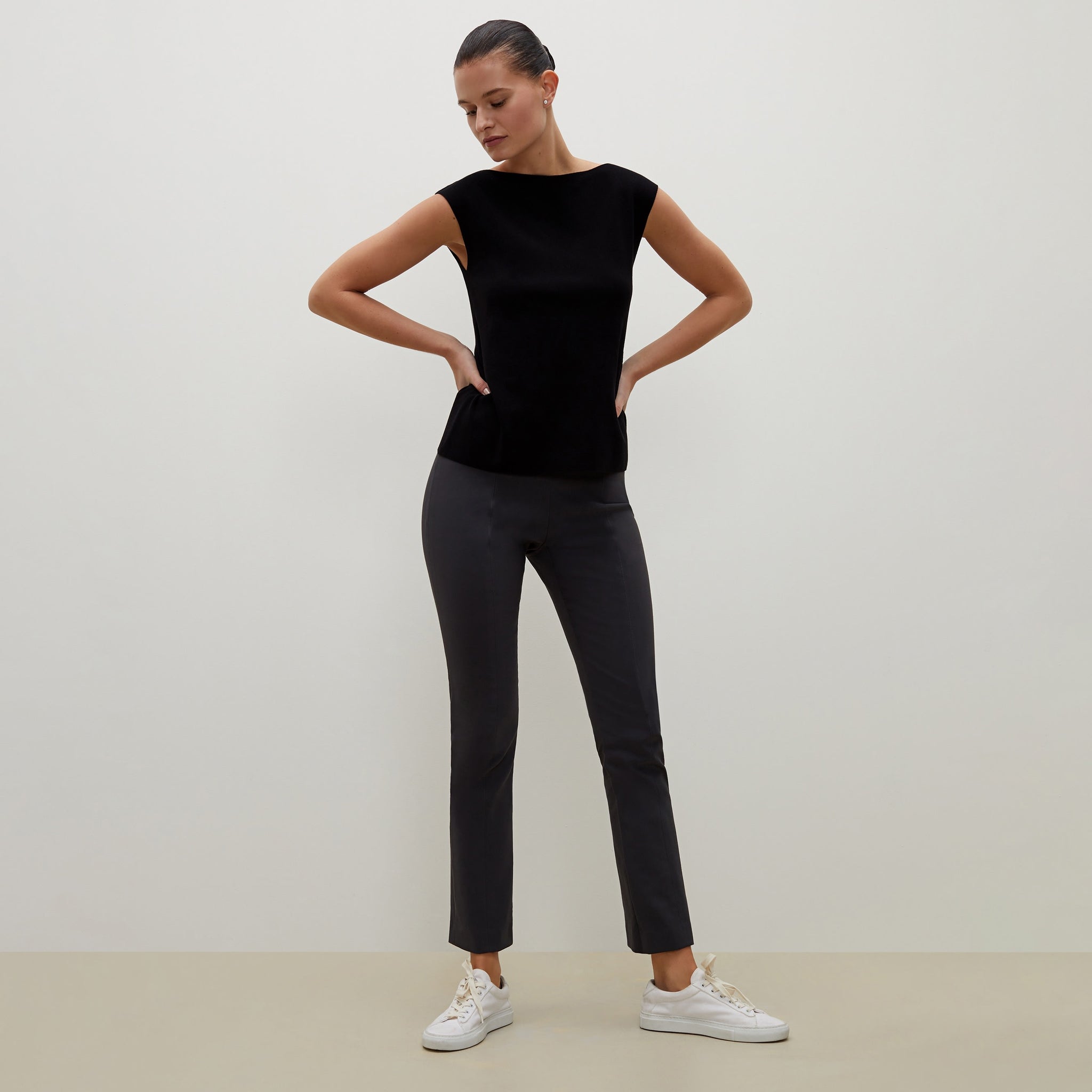 Front image of a woman standing wearing the Eileen top in black 