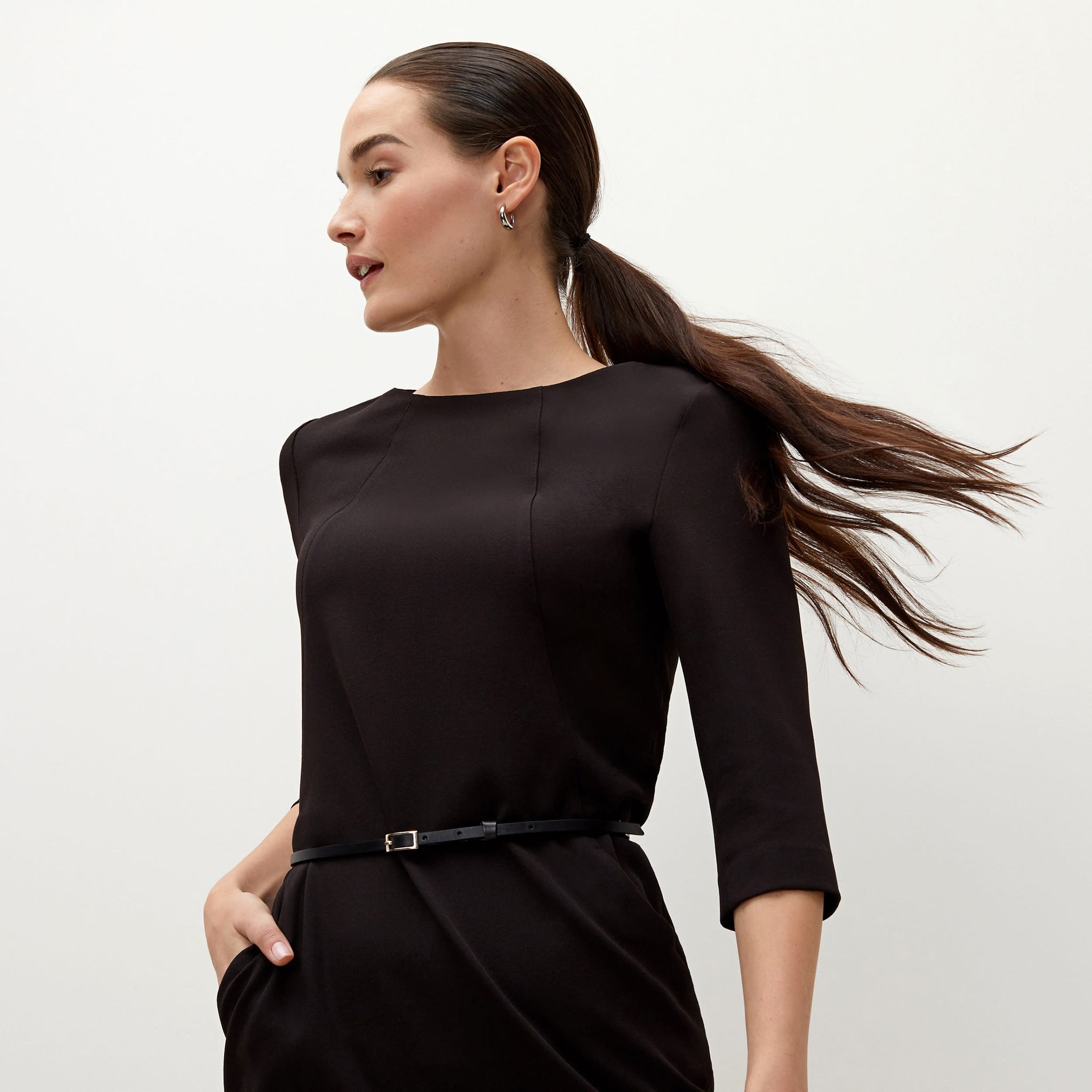 Detail image of a woman standing wearing the Etsuko dress in black