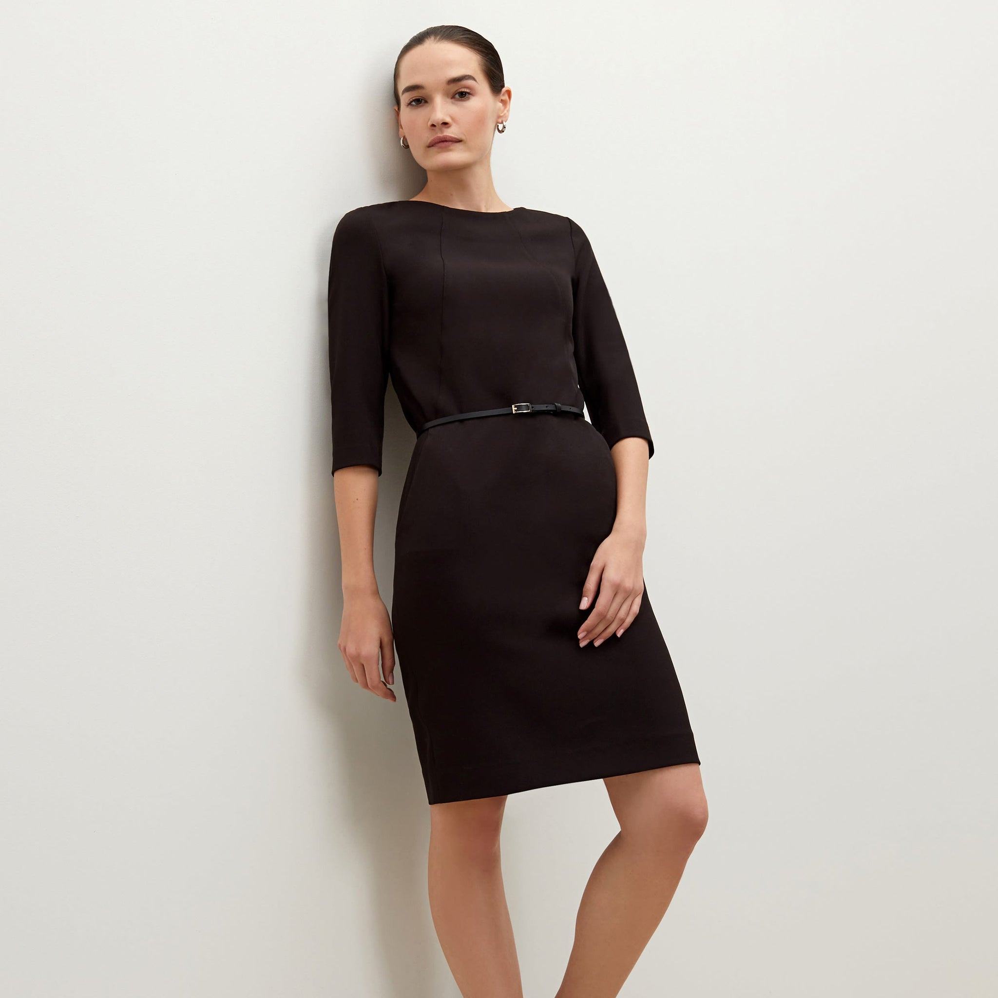 Side image of a woman standing wearing the Etsuko dress in black