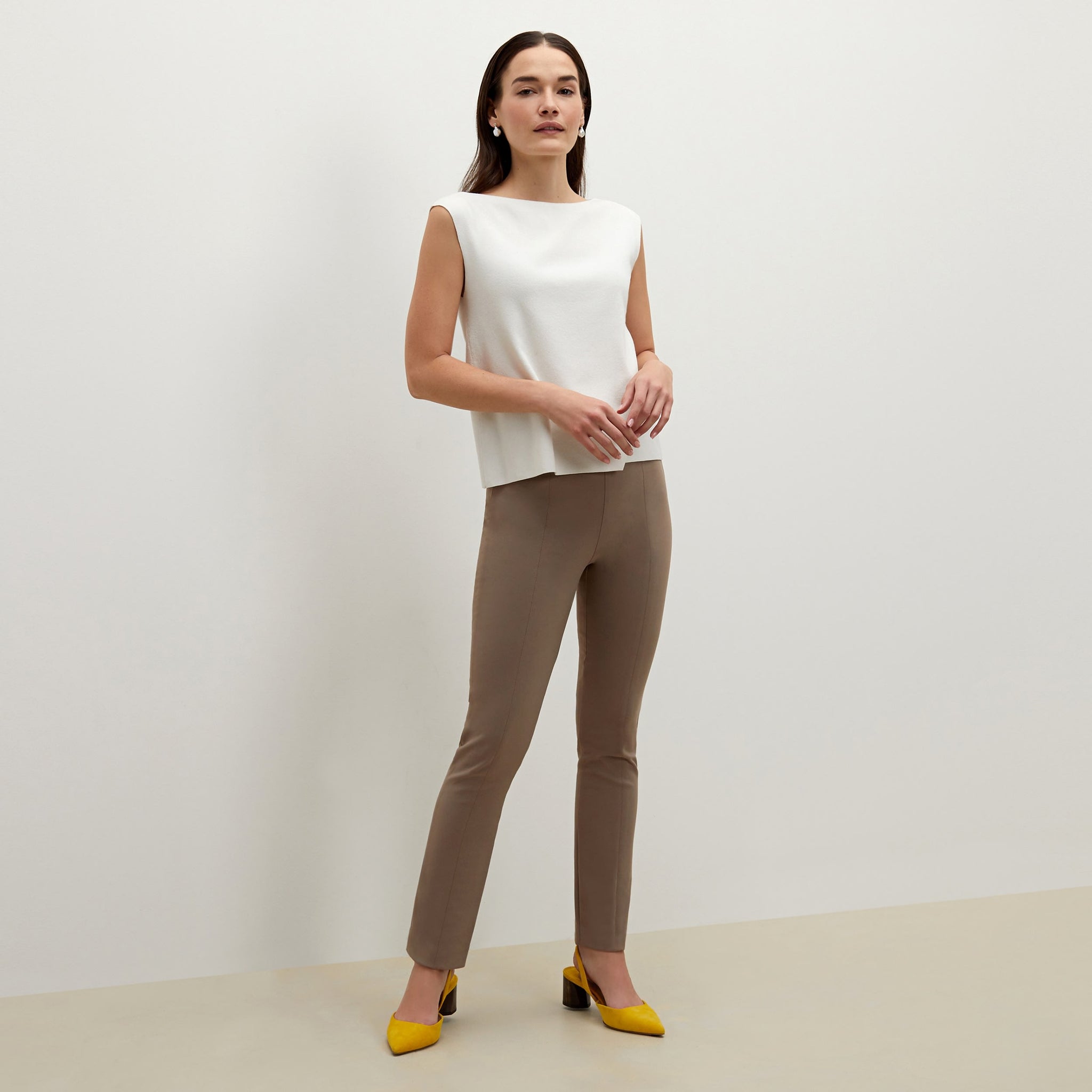 Side image of a woman standing wearing the foster pant in russet 