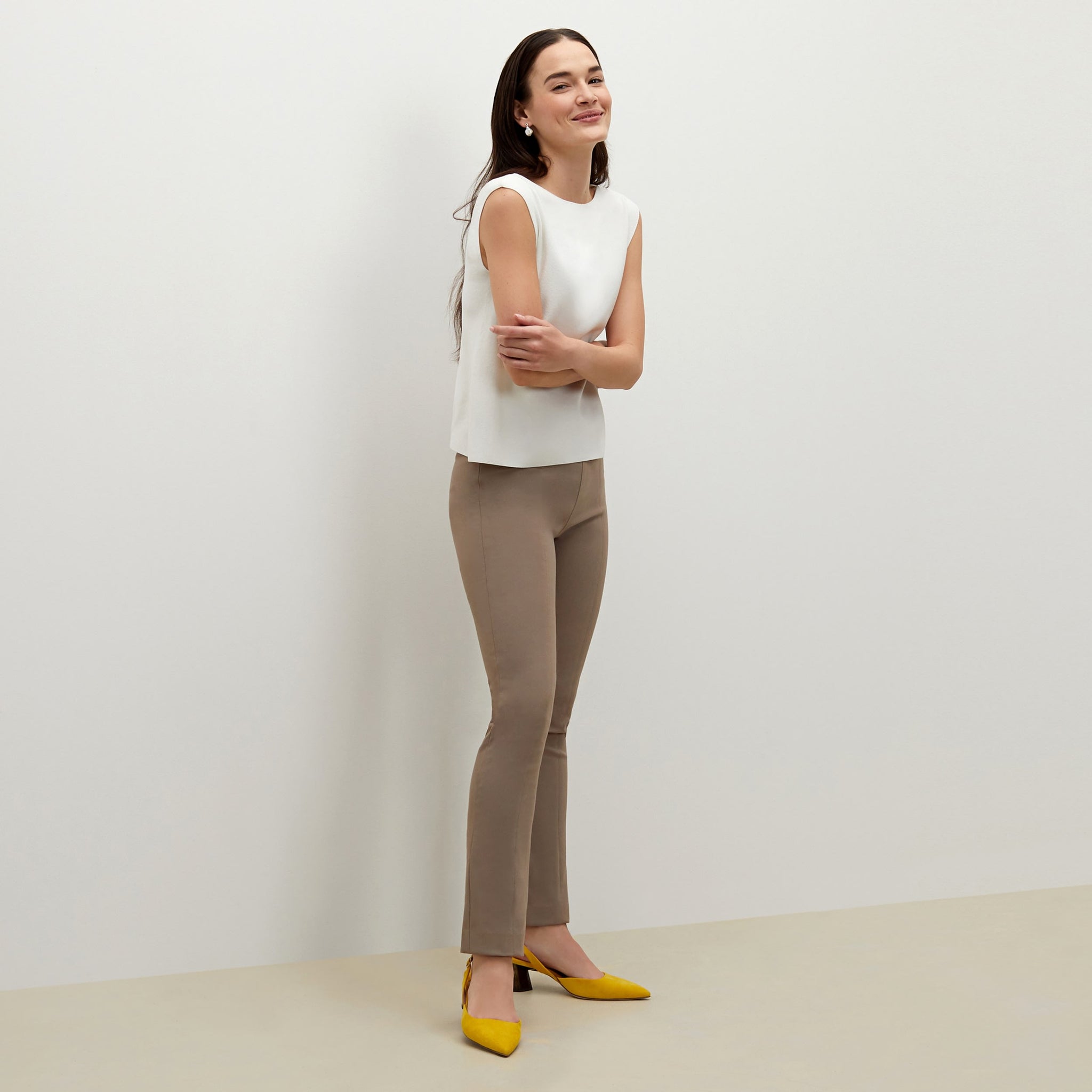 Side image of a woman standing wearing the foster pant in russet