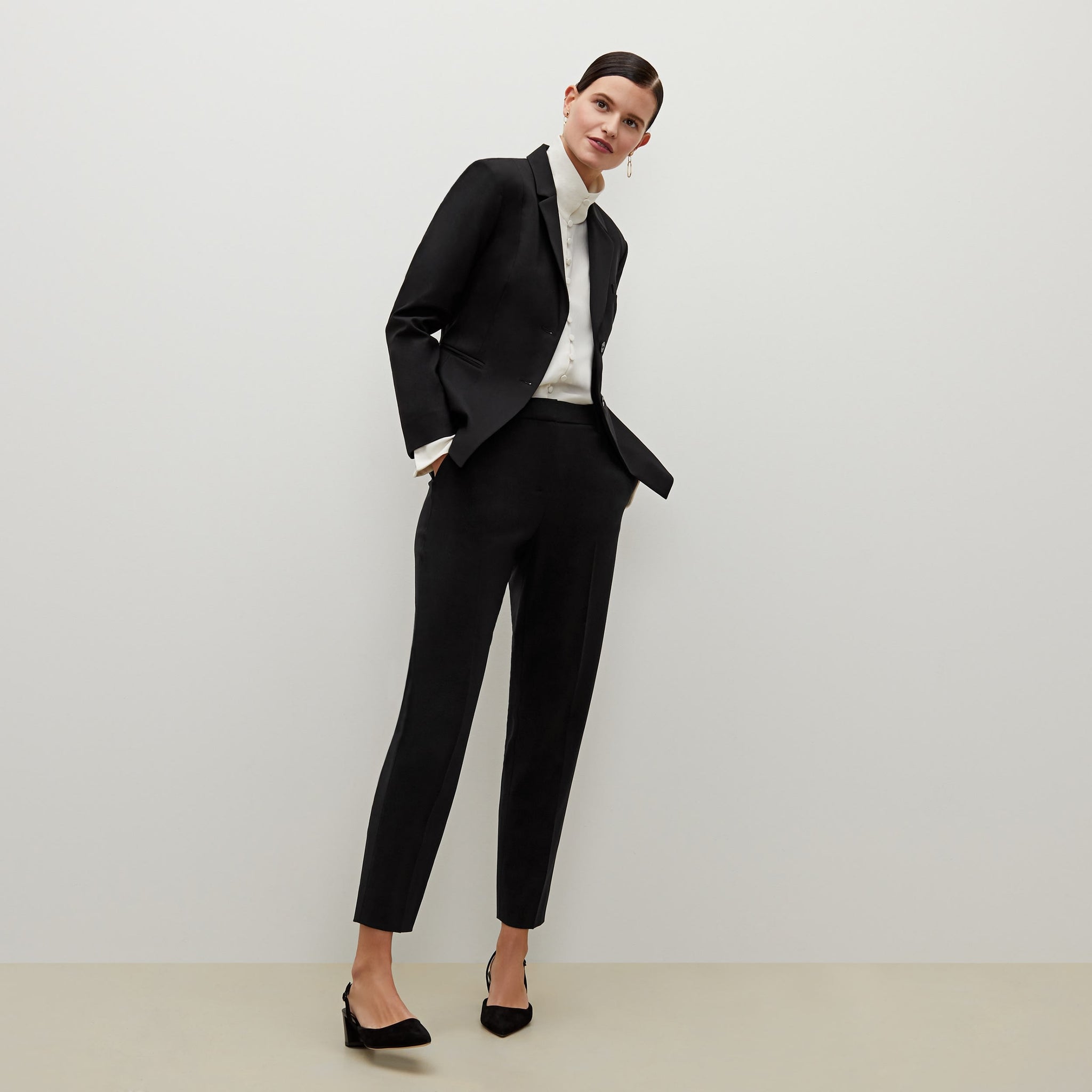 Front image of a woman standing wearing the Hoffman blazer in Black 