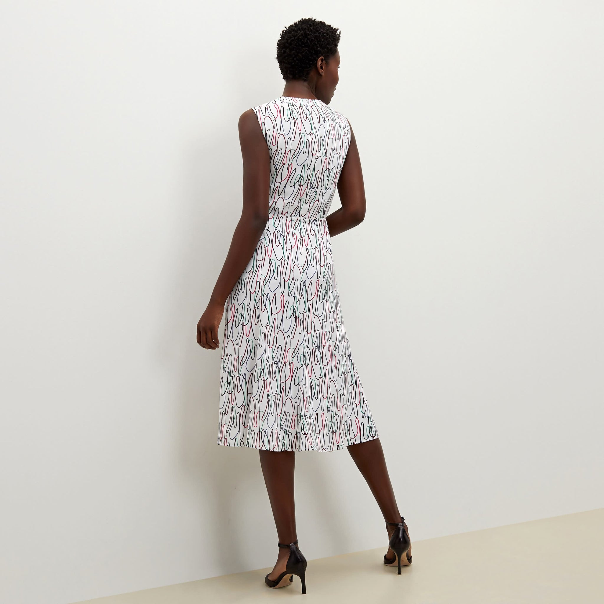 Back image of a woman standing wearing the Jane dress in multicolor