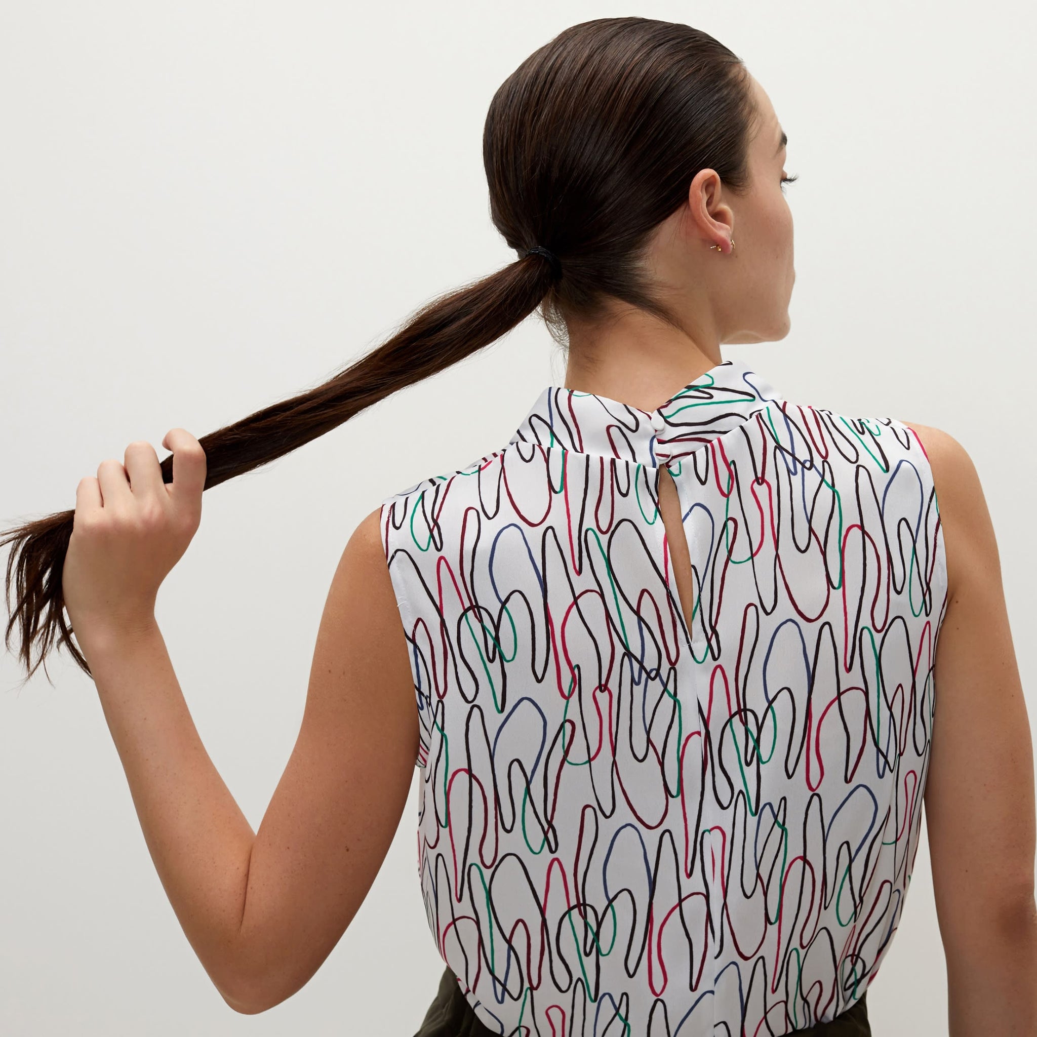 Back image of a woman standing wearing the Lise top in multicolor
