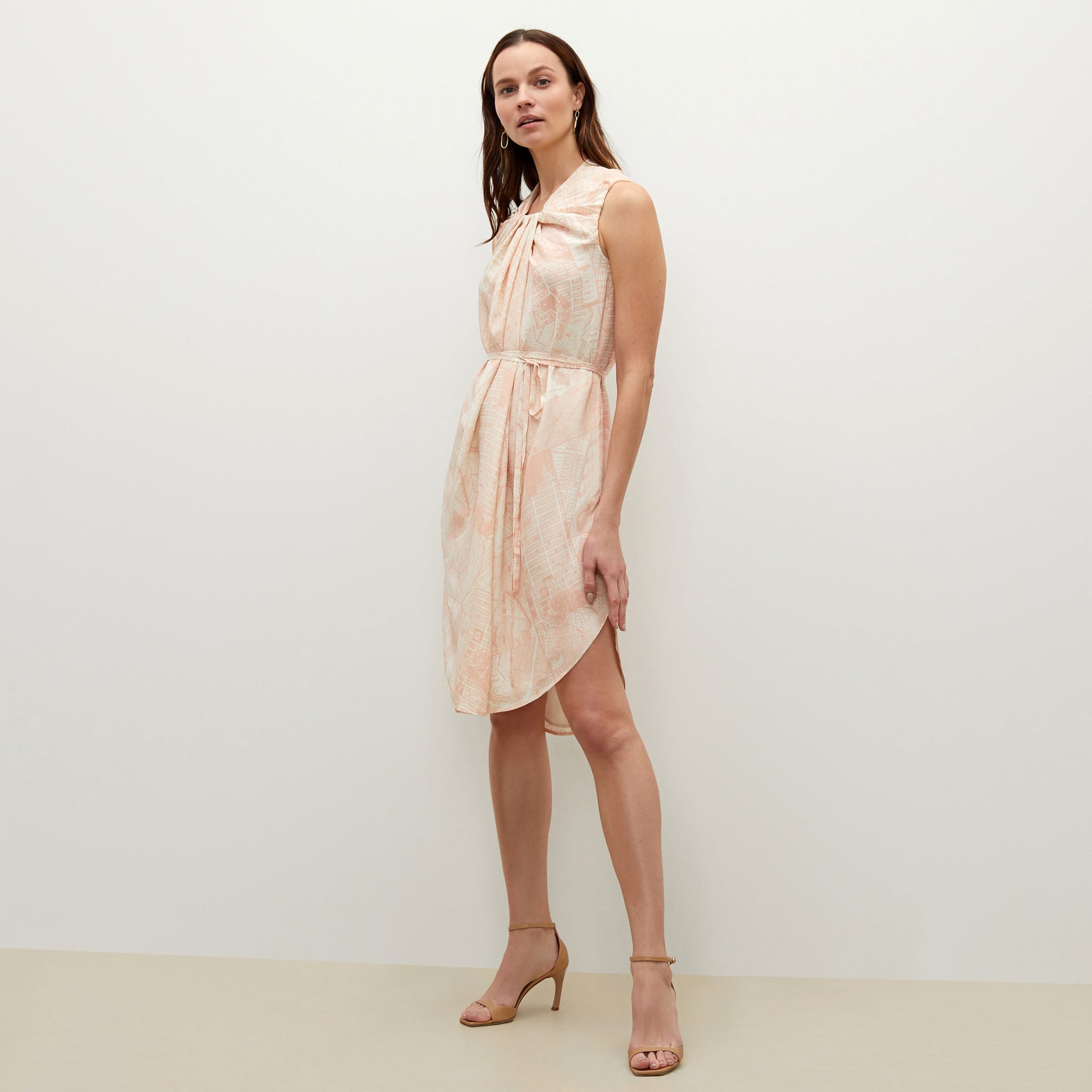 Side image of a woman standing wearing the Maite dress in ivory / cameo