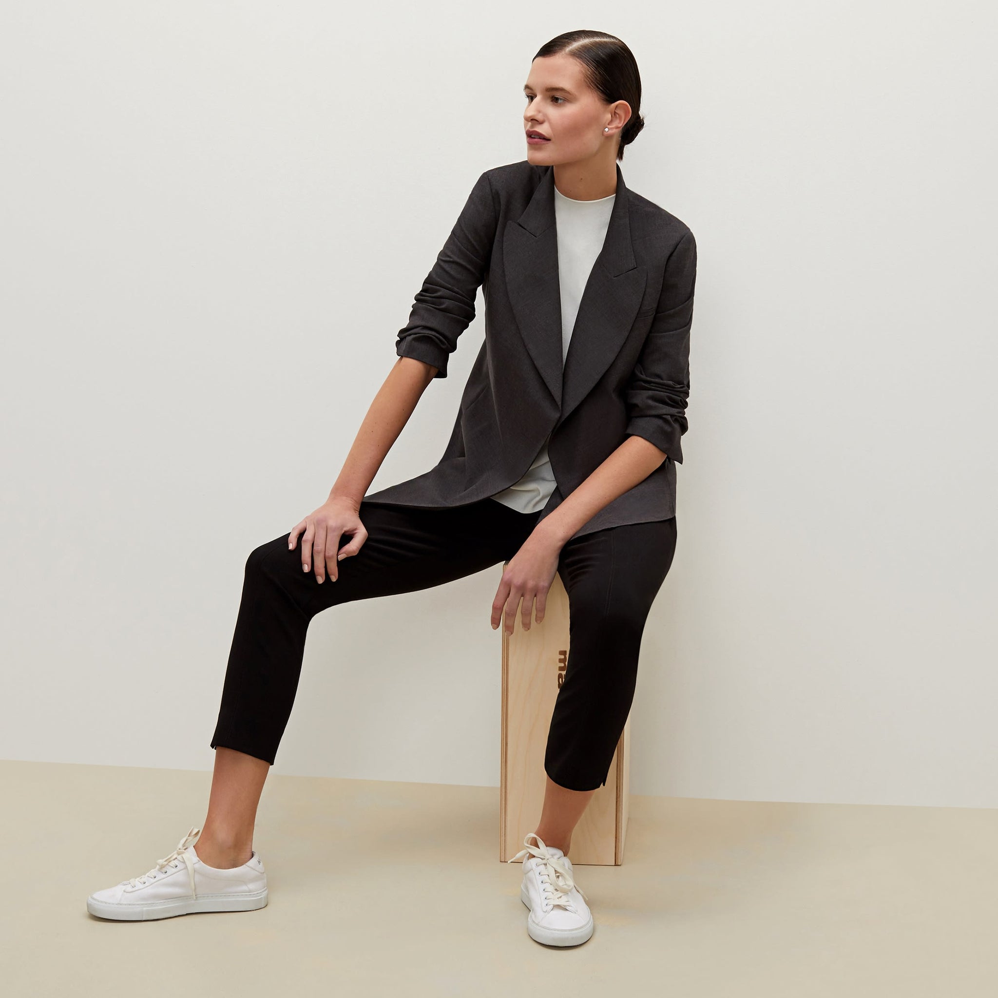 Side image of a woman standing wearing the Marais pant in black