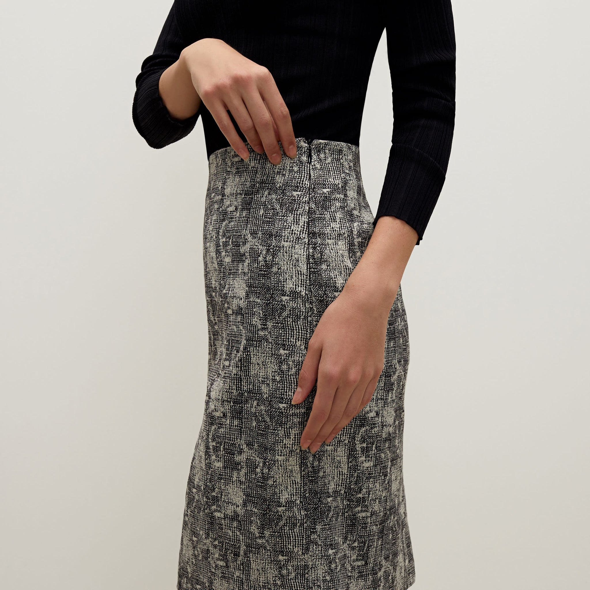 Side image of a woman standing wearing the Noho skirt in crackle