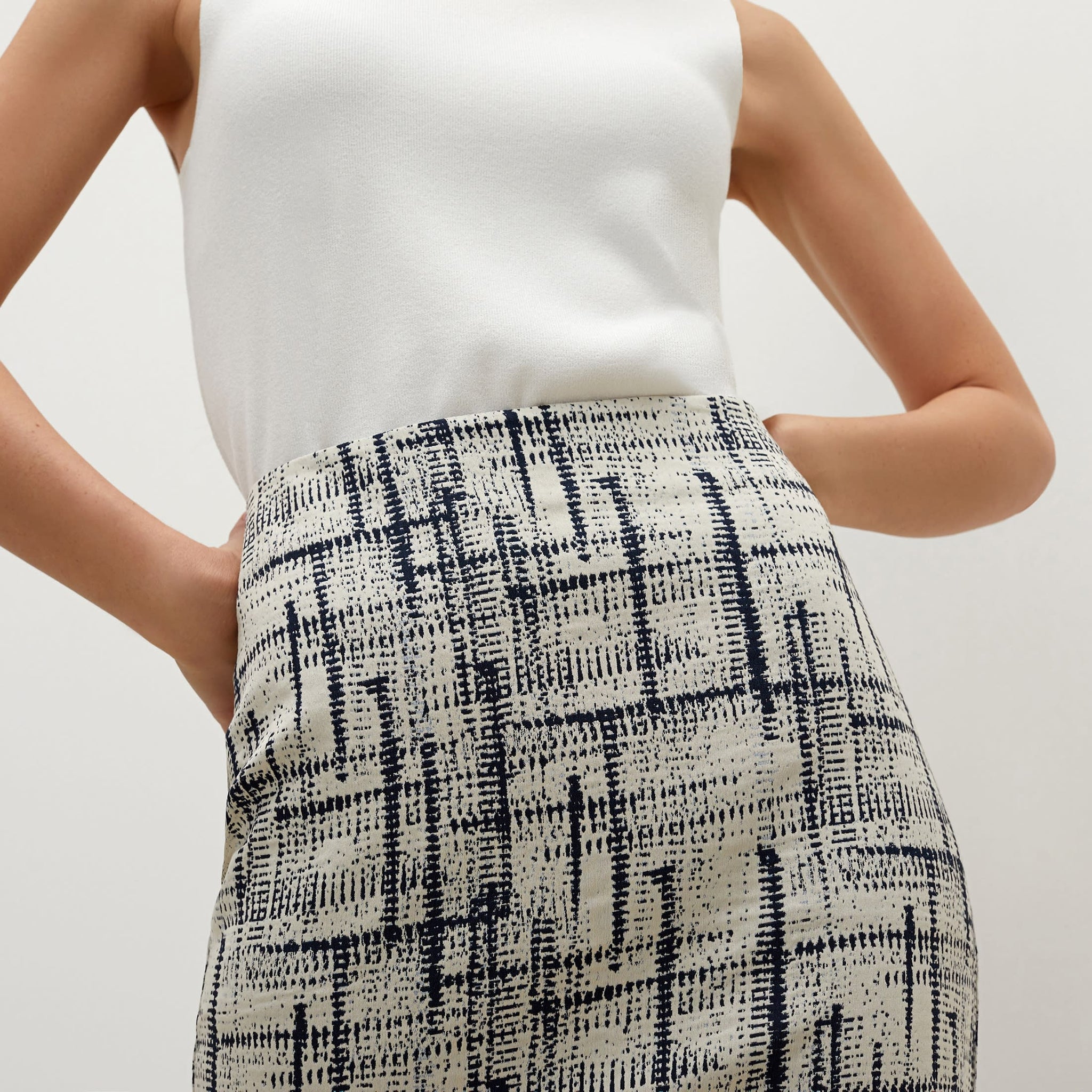 Detail image of a woman standing wearing the Noho skirt in ivory / galaxy blue