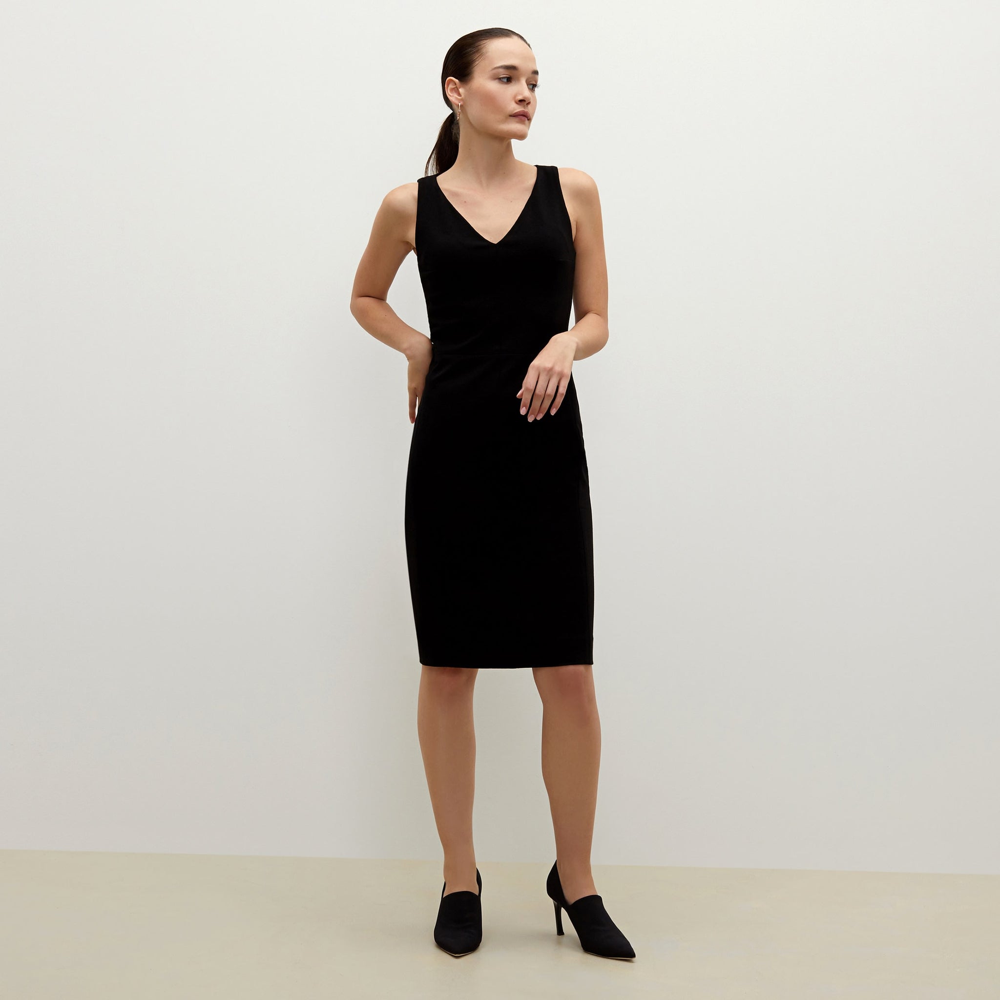 Front image of a woman standing wearing the Rachel dress in black 