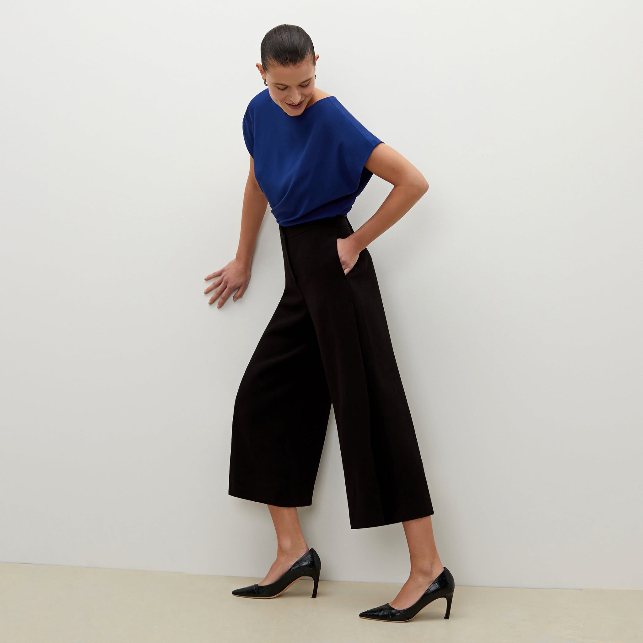 Side image of a woman standing wearing the Zhou culotte in black