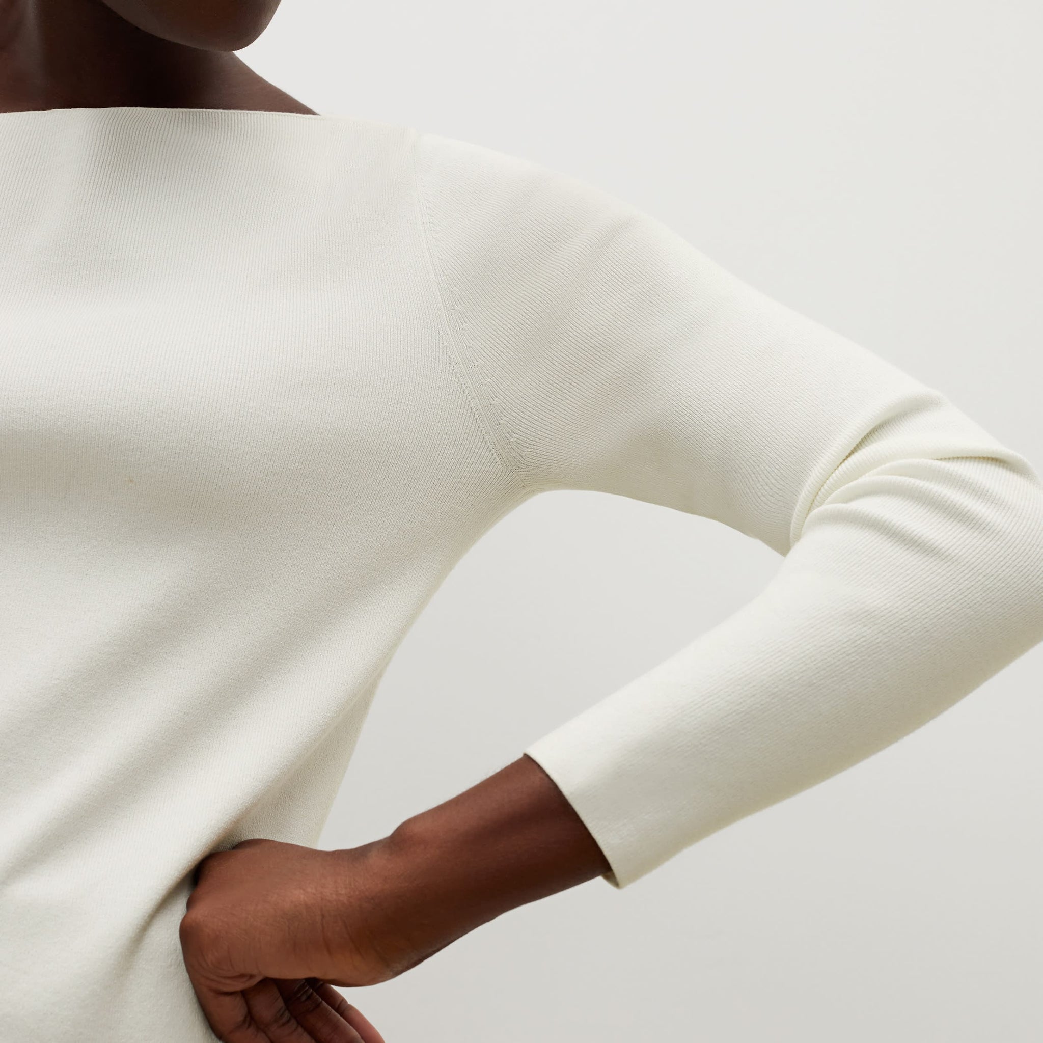 Detail image of a woman standing wearing the celeste top in ivory