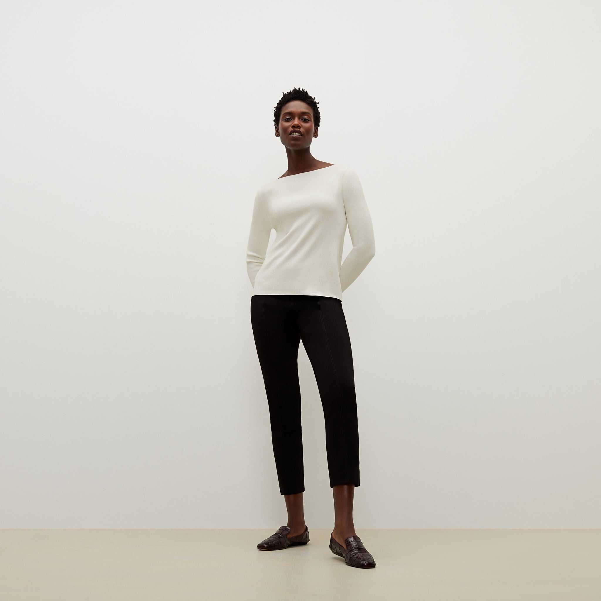 Front image of a woman standing wearing the celeste top in ivory