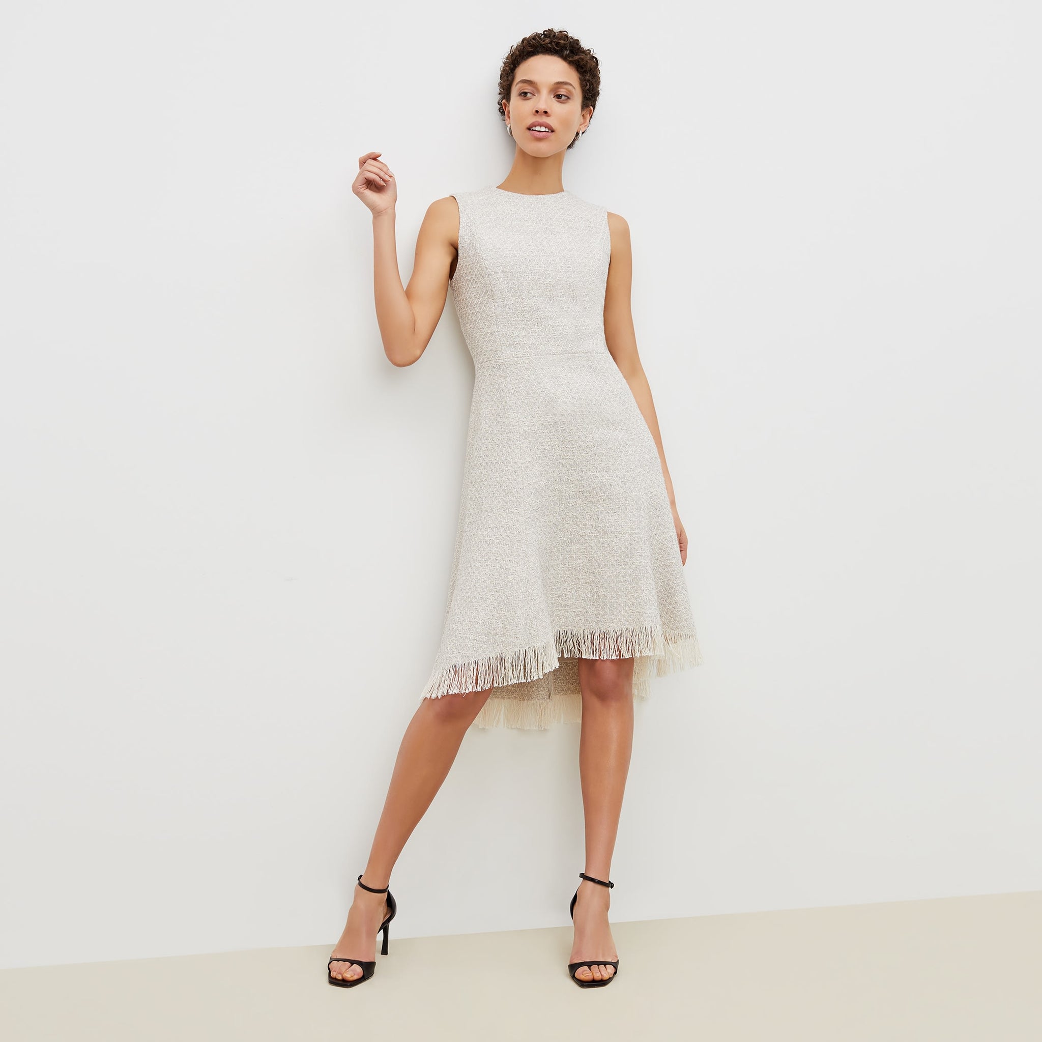 Front image of a woman standing wearing the lindsay dress cotton boucle in sea salt / ivory 