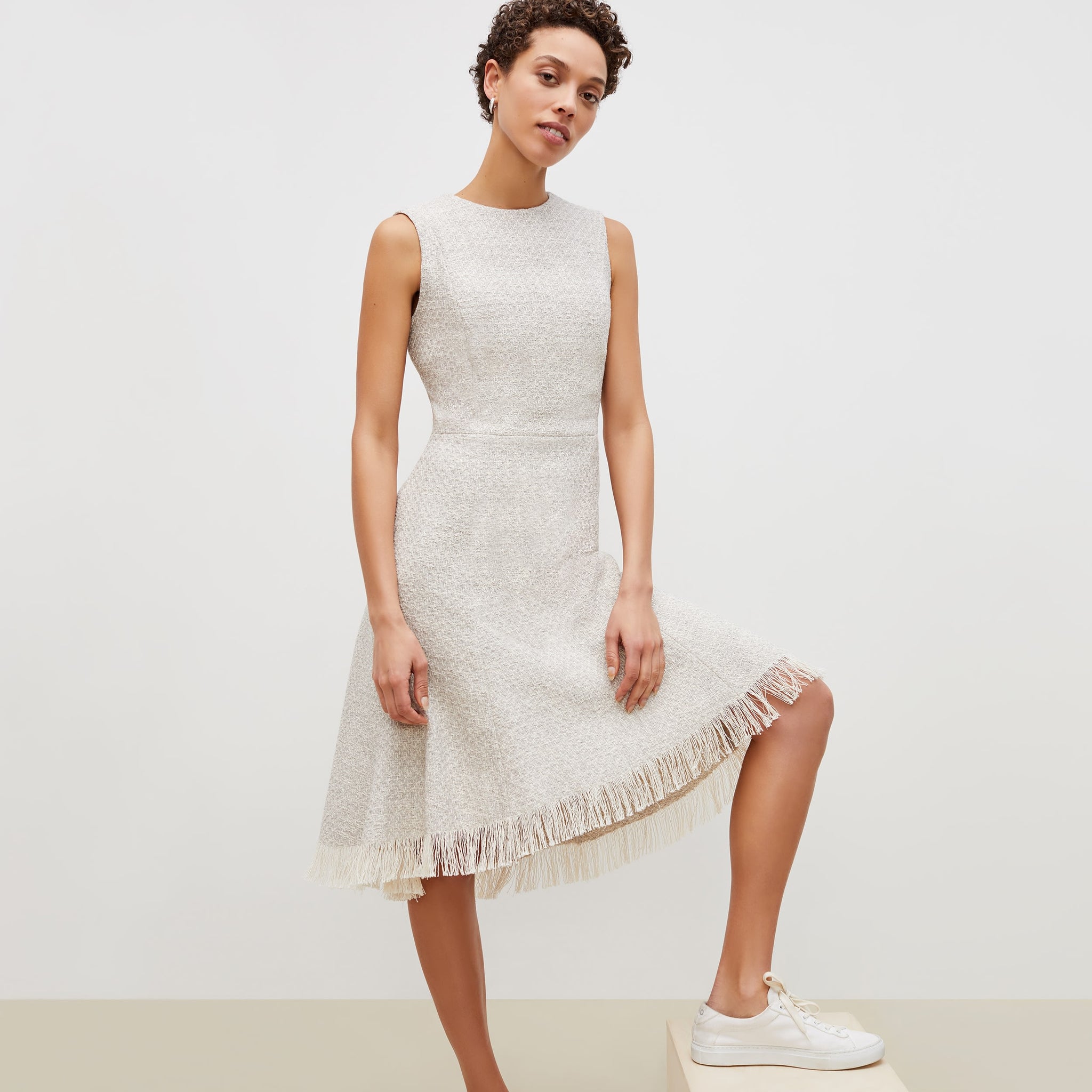 Front image of a woman standing wearing the lindsay dress cotton boucle in sea salt / ivory