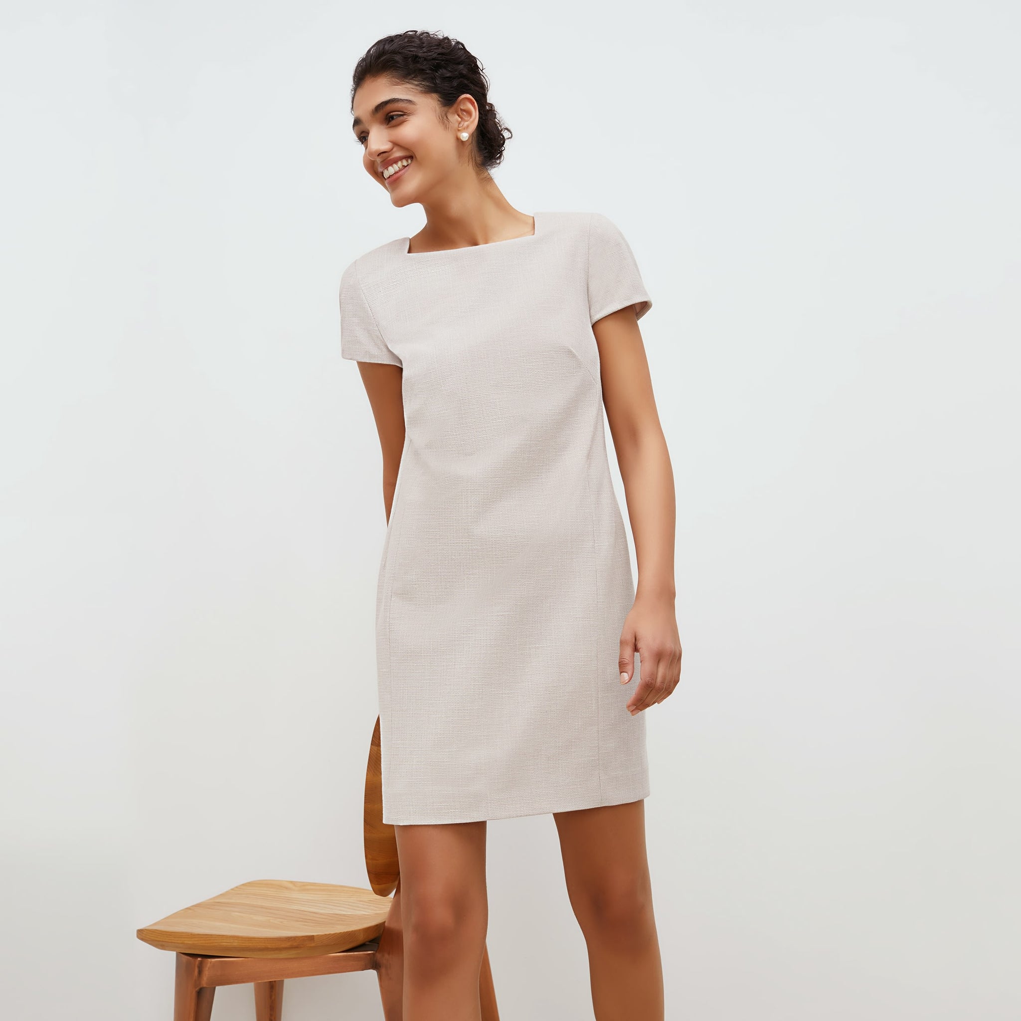Front image of a woman standing wearing the marie dress in crosshatch in dove 