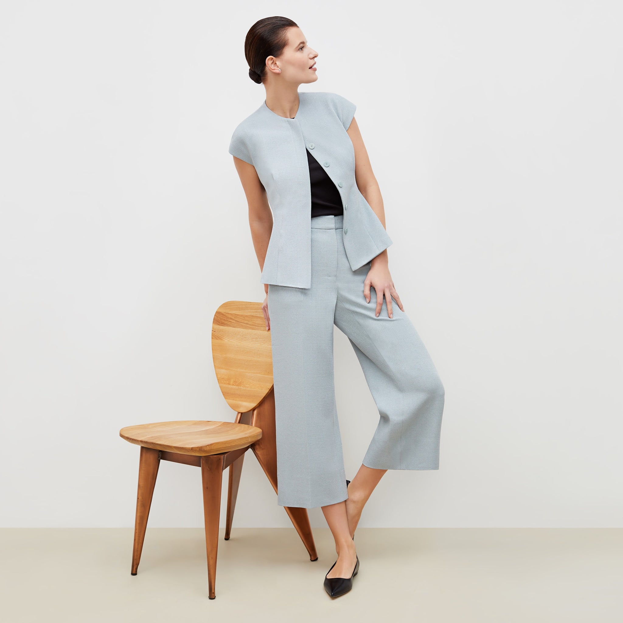 Front image of a woman standing wearing the anderson pant in textured suiting in powder blue 
