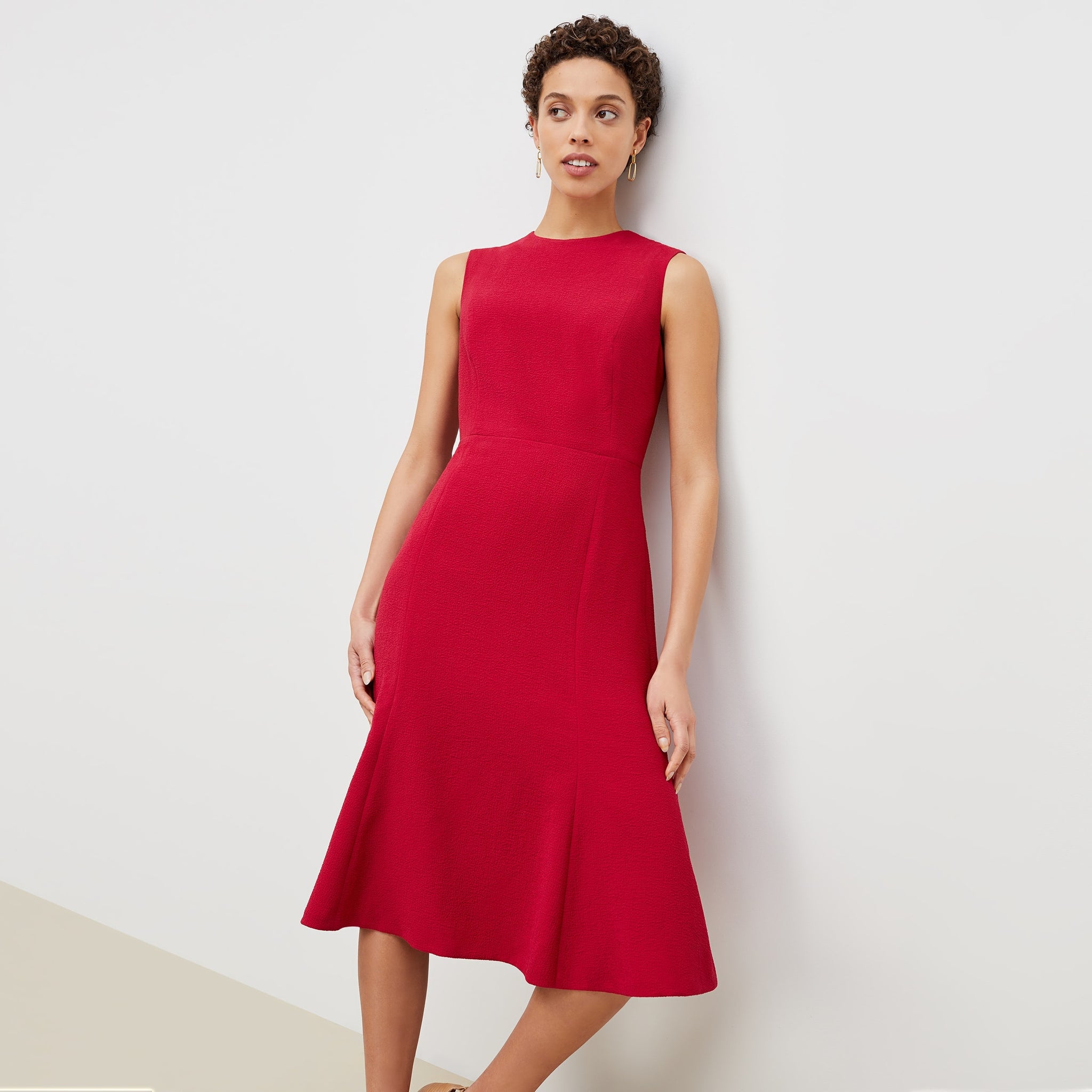 Front image of a woman standing wearing the jane dress in staccato in hibiscus